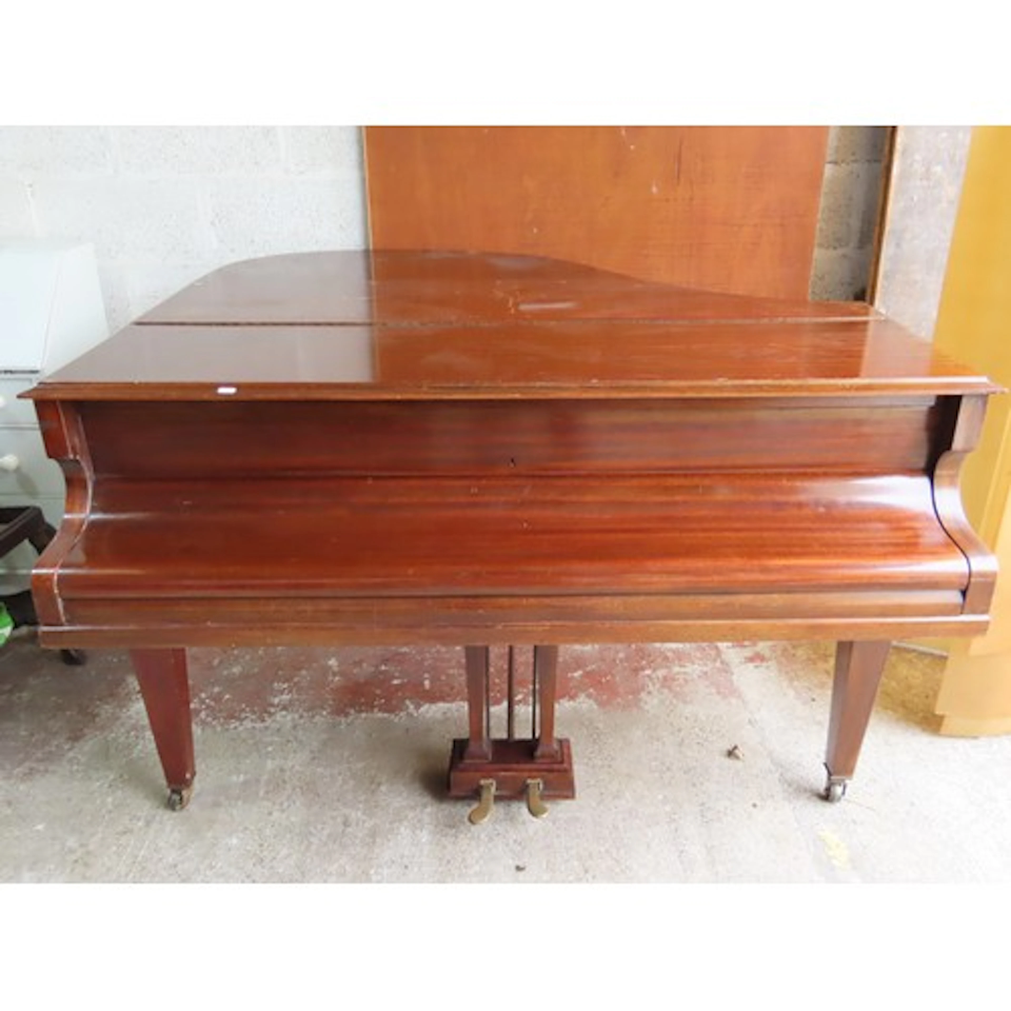 A baby grand piano by Challen, with iron frame over strung a...