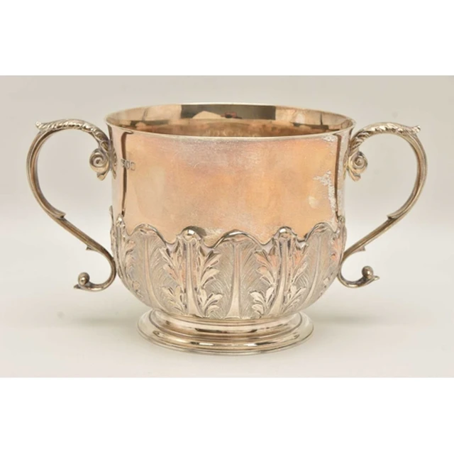 AN EARLY 20TH CENTURY SILVER TWIN HANDLED CUP, decorated wit...