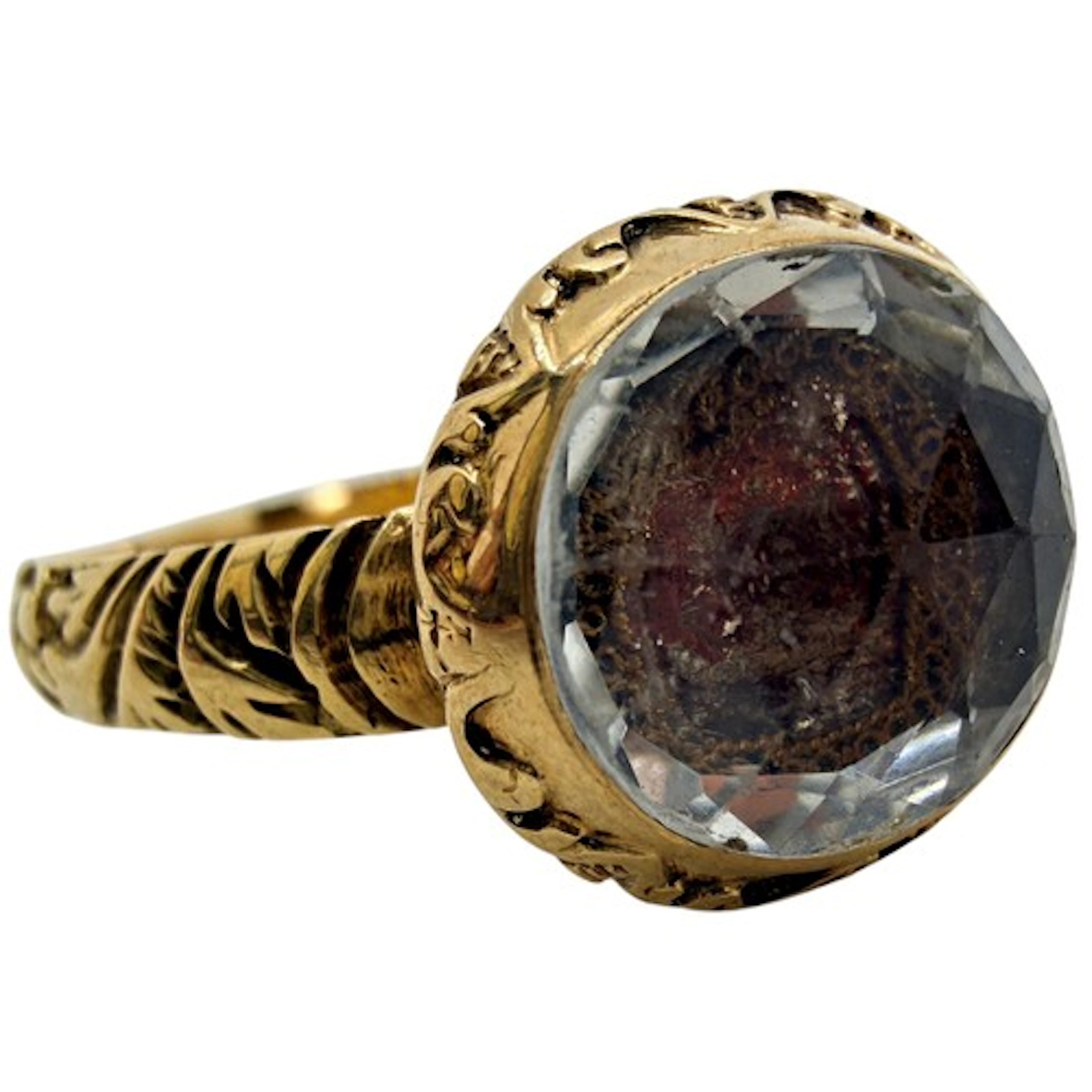 A rare high-carat gold ring set with a large domed rock crys...