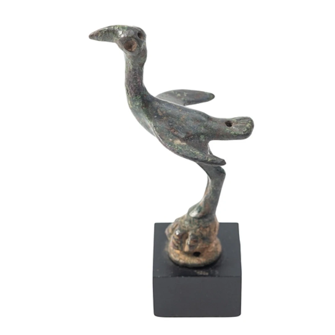 AN ITALIC BRONZE MODEL OF A BIRD CIRCA 6TH CENTURY B.C., 9.7...