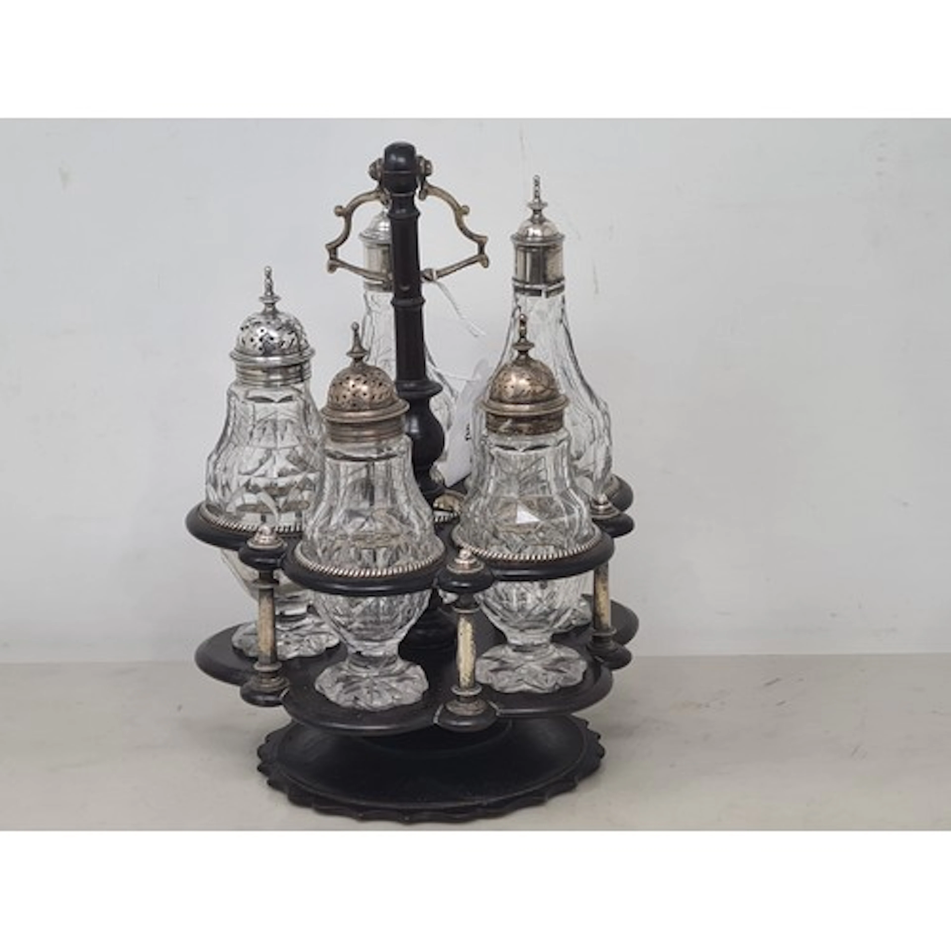 A Georgian five bottle Cruet on revolving ebonised stand wit...