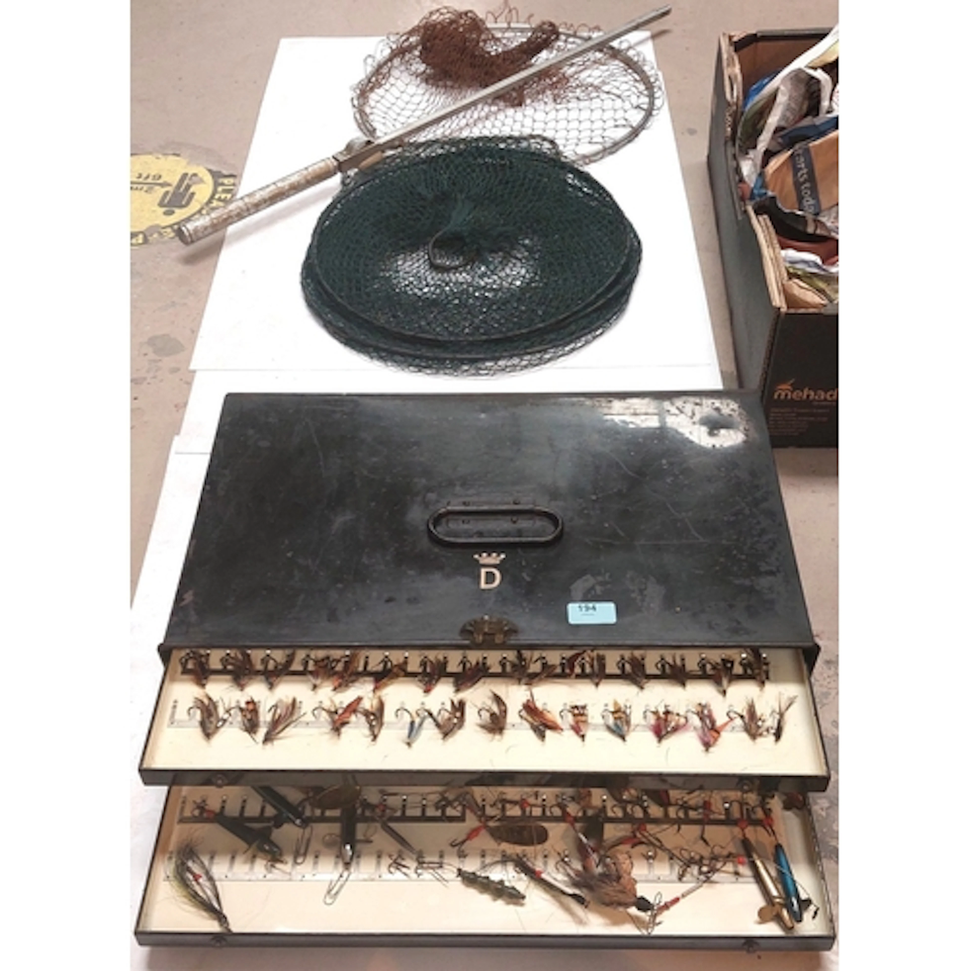 A vintage metal fly fishing lure box with black finish and c...