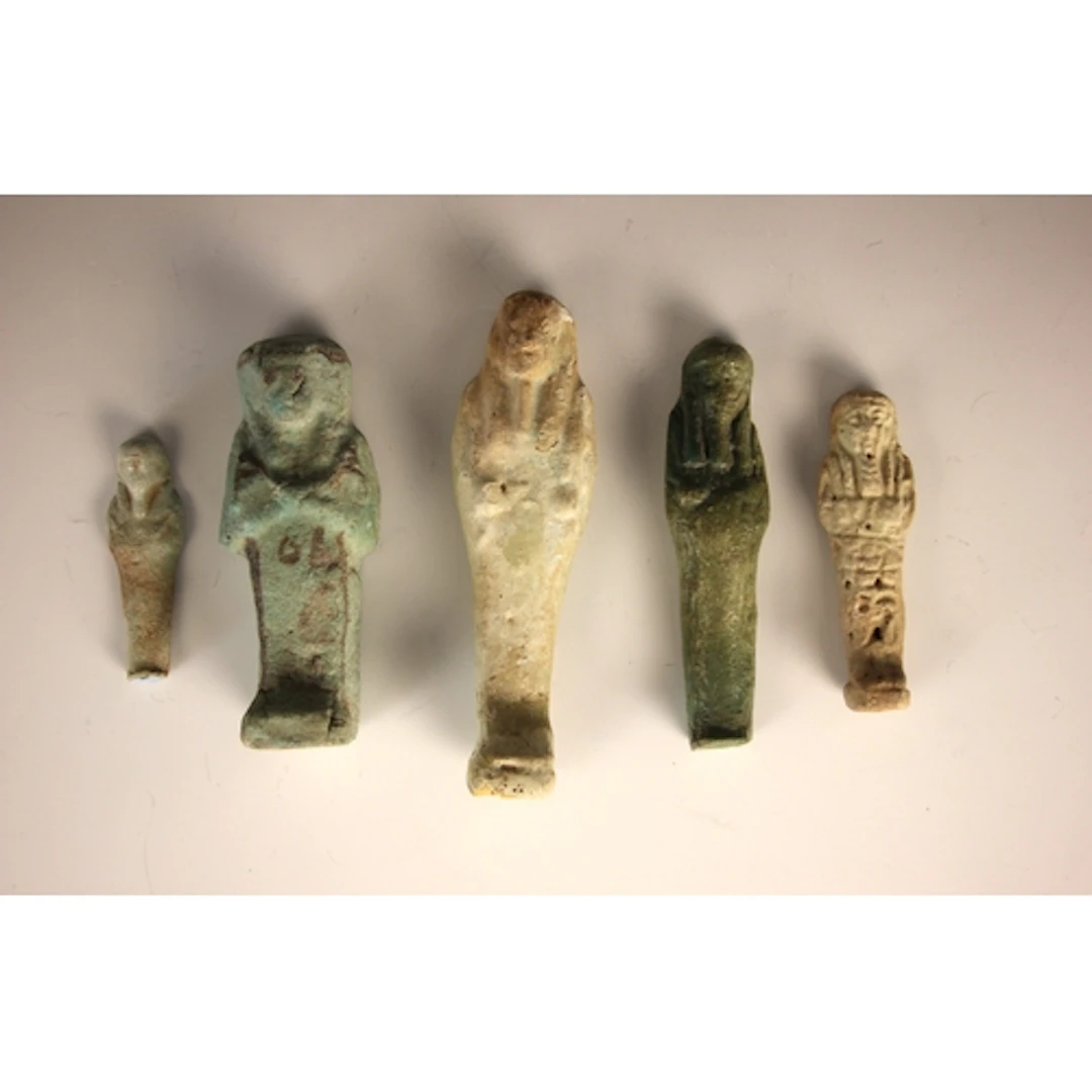 An Egyptian faience Shabti, of typical form, modelled standi...