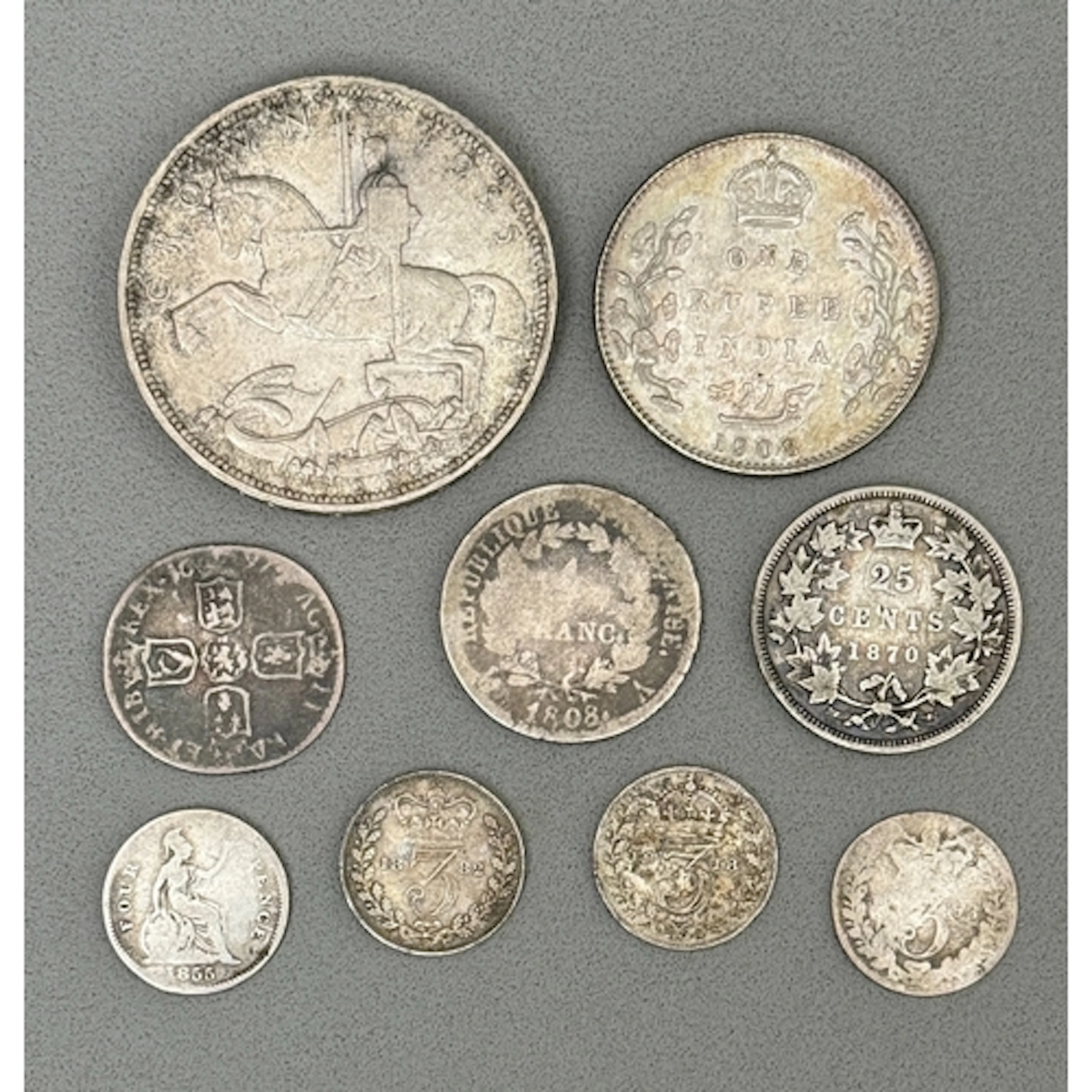 Six British and three world silver coins - a 1935 George V...
