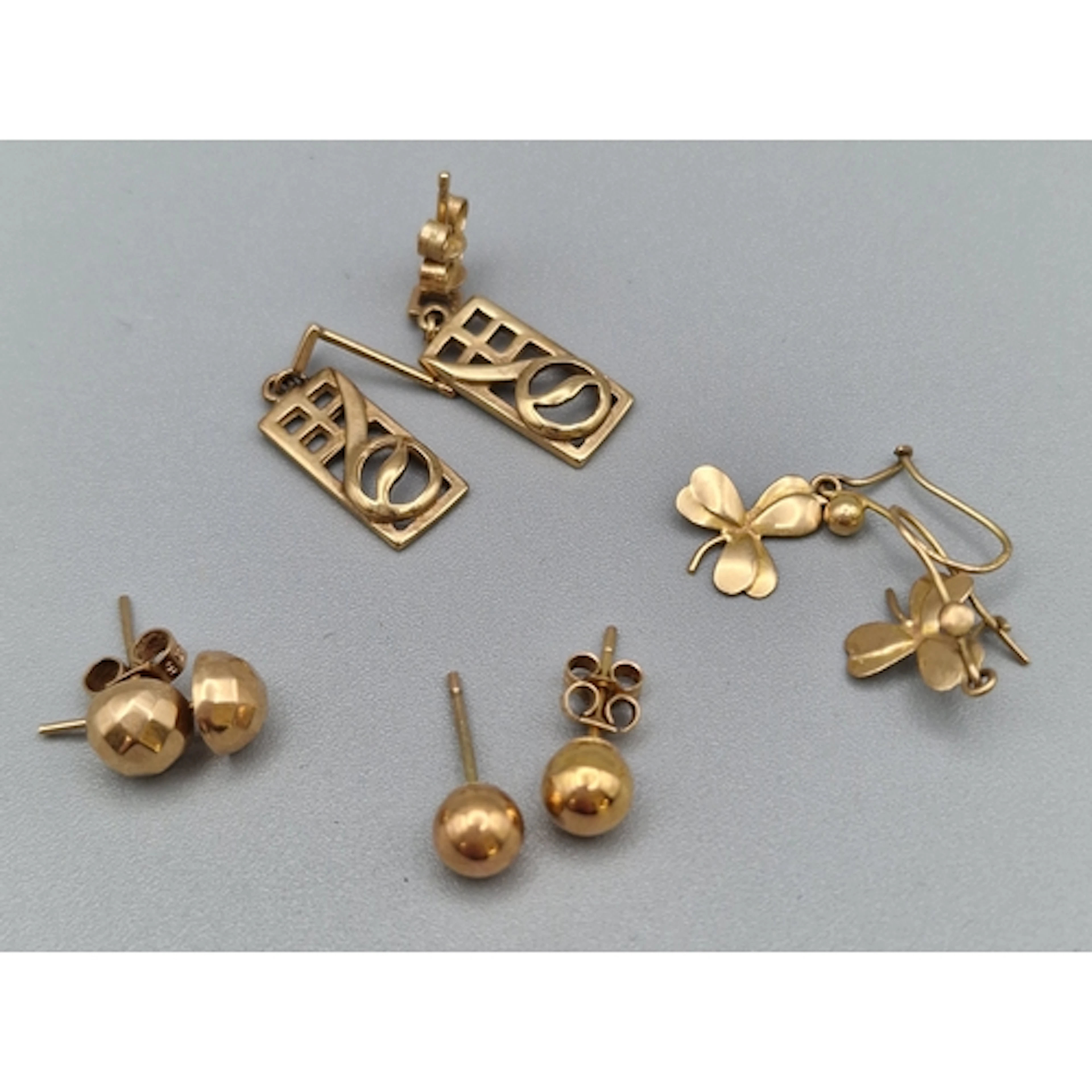 Four pairs of 9ct gold earrings, one in the style of Charles...