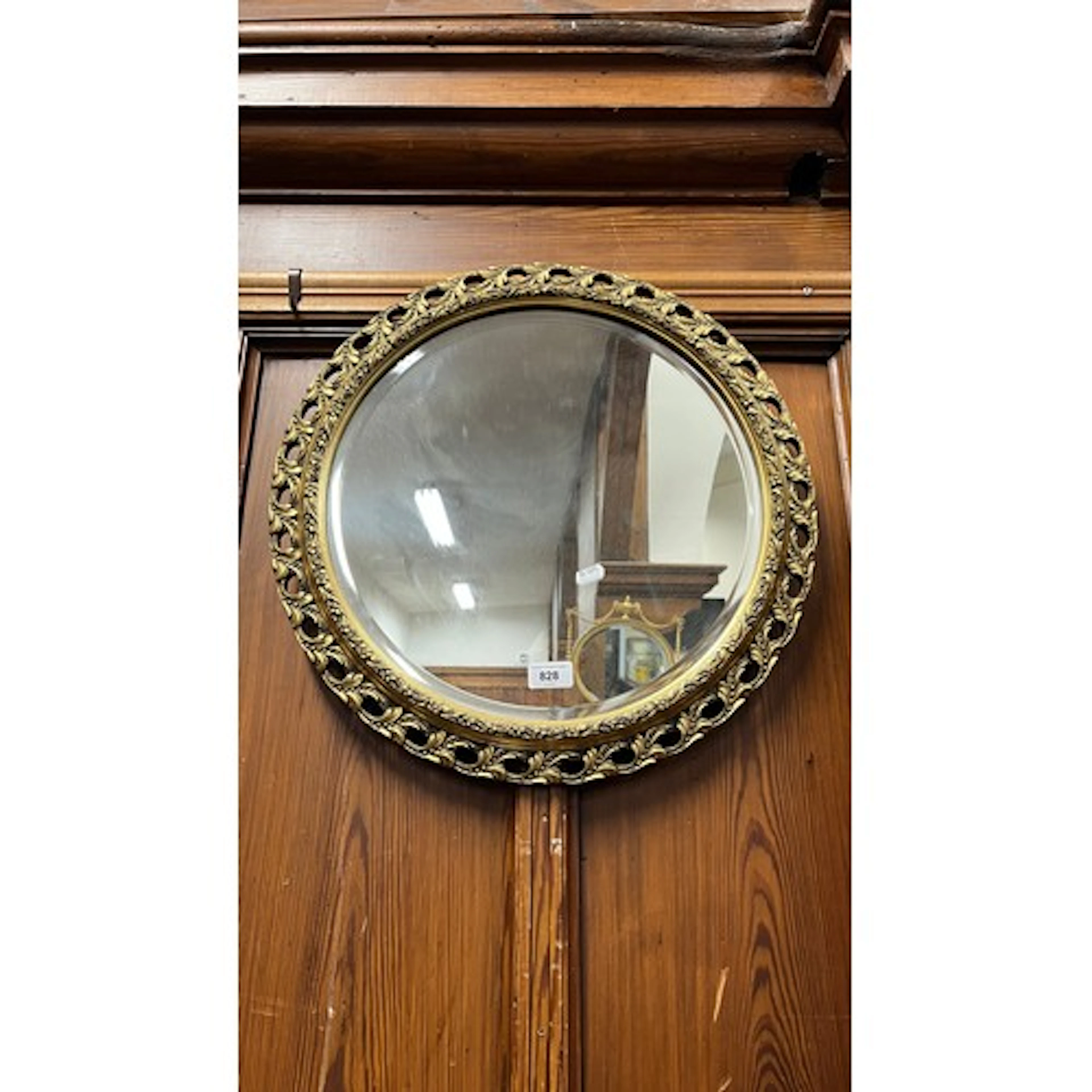 Gilt framed circular wall mirror, 52cm diameter.