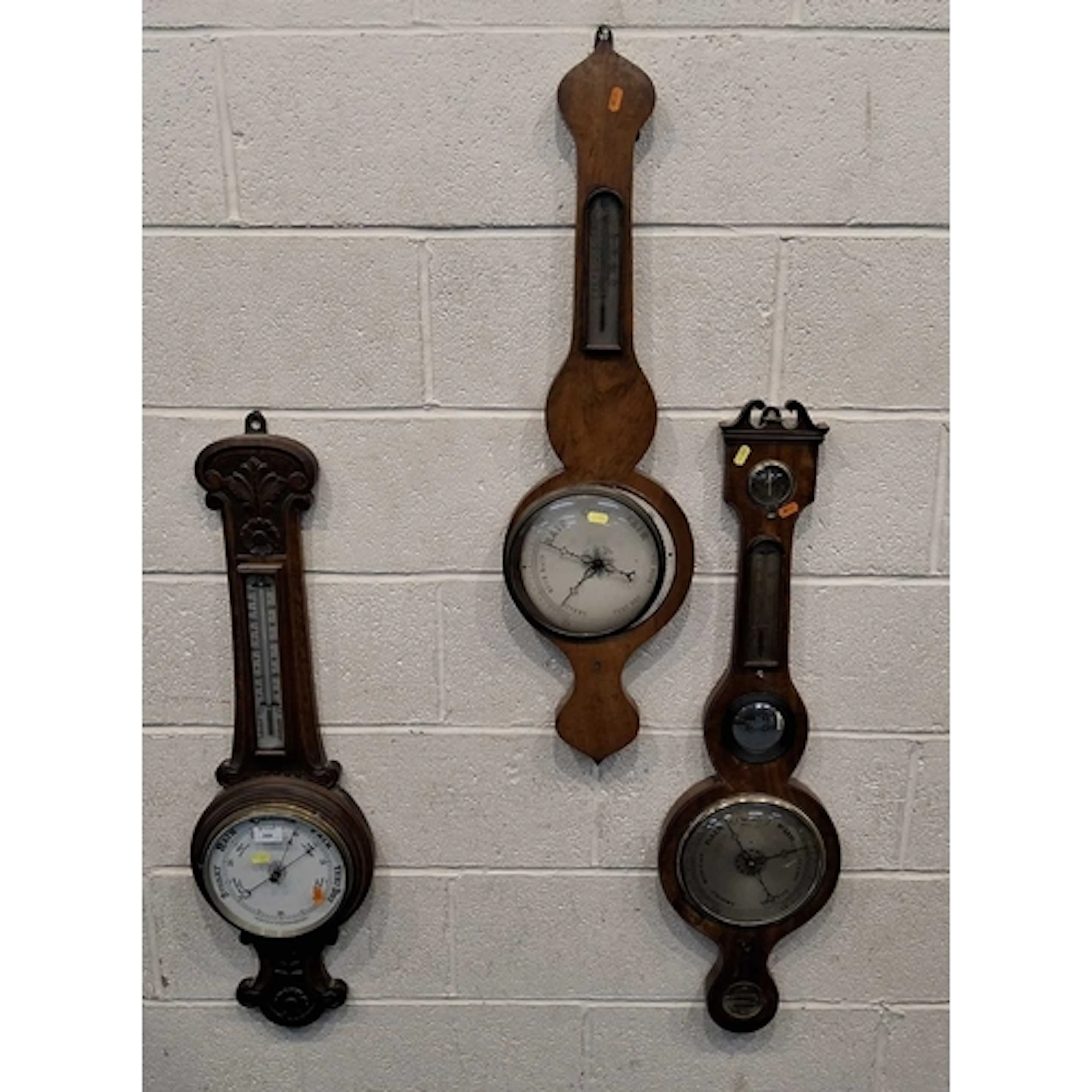 THREE BAROMETERS, varying in shape, size, style, timber, per...