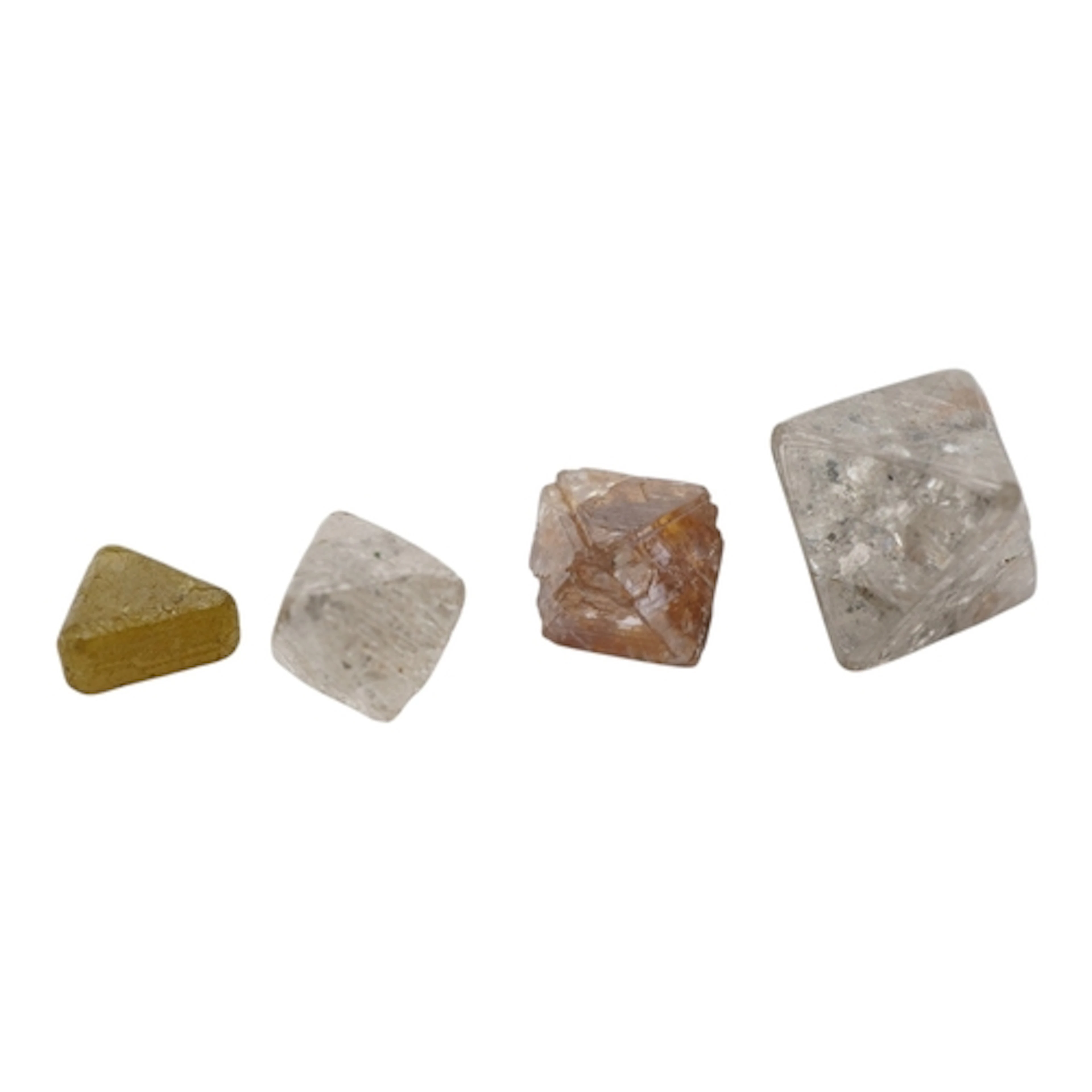 Four uncut diamonds, comprising: three octahedron crystals, ...