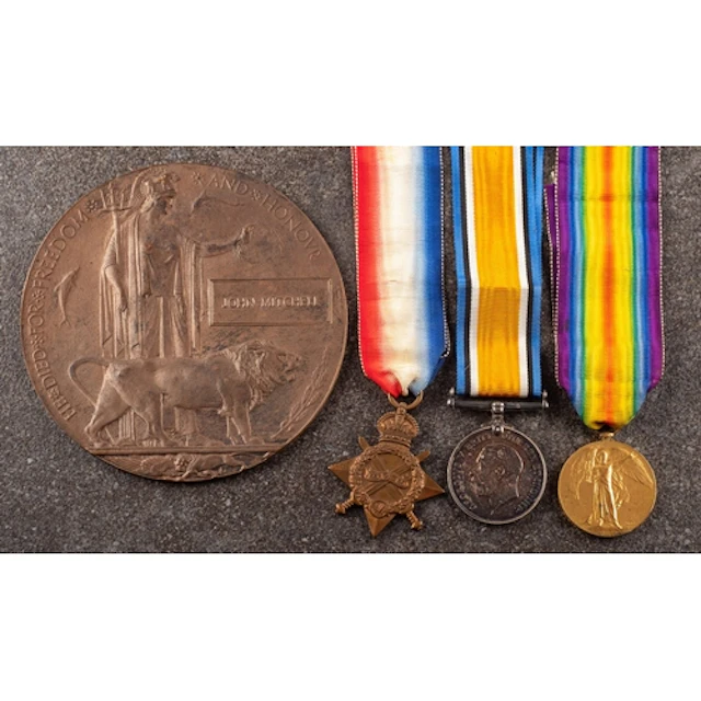 A WWI Trio and death plaque to '9897 Pte J Mitchell Manch R'...