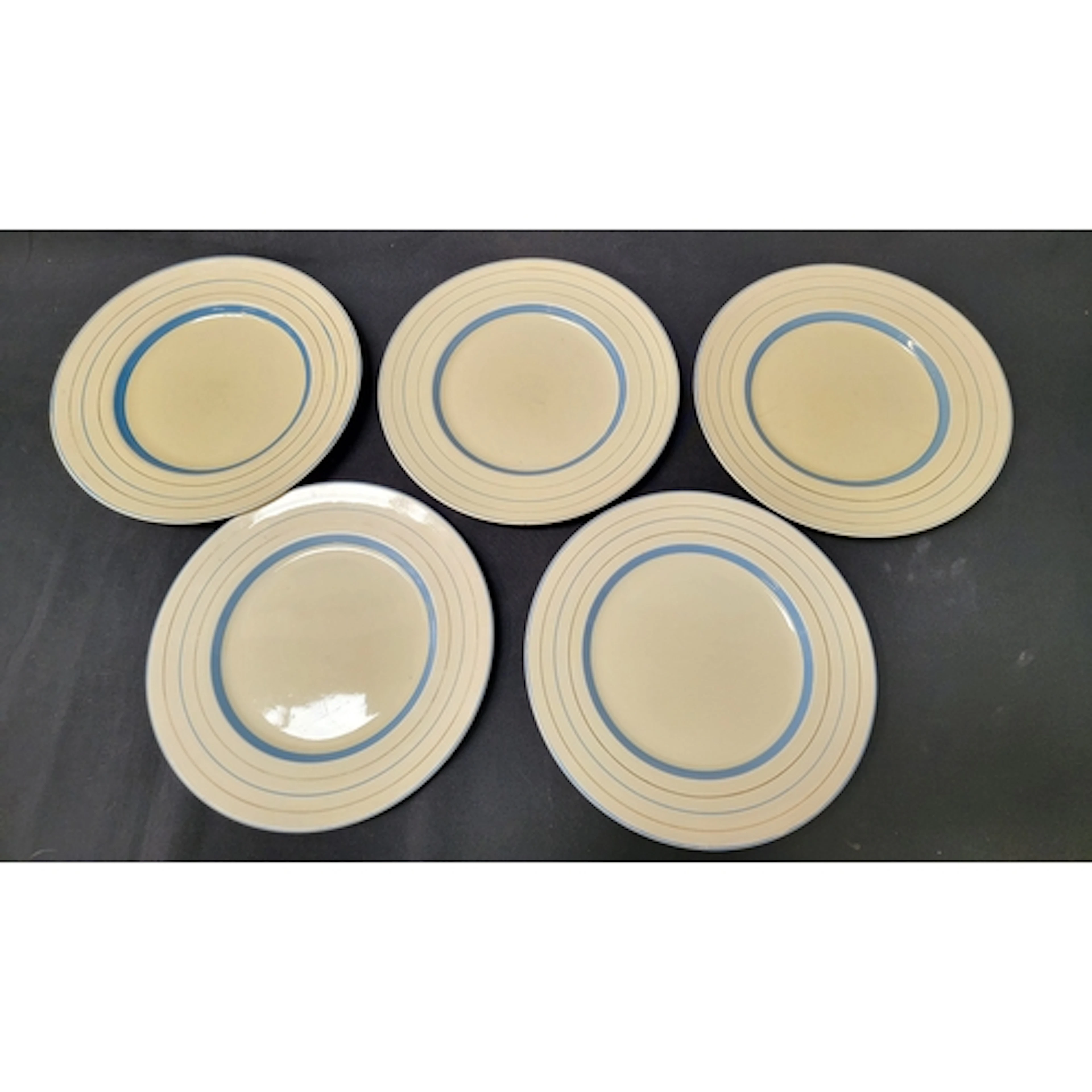 THREE CLARICE CLIFF PLATES featuring cream ground with blue...