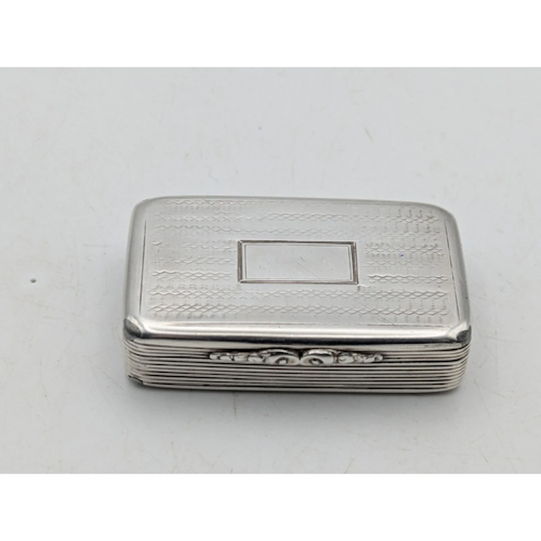 A William IV silver snuff box having engraved decoration, wi...