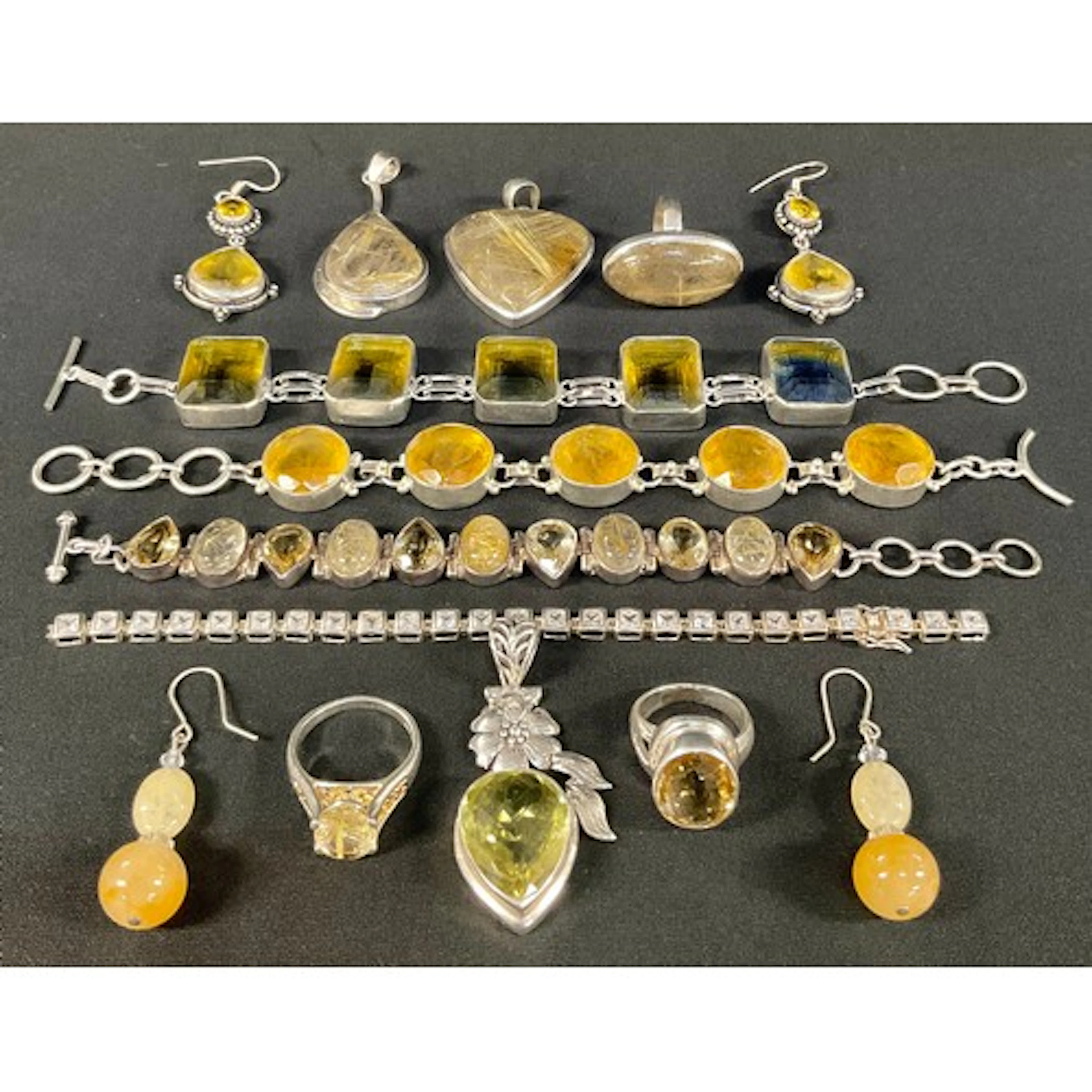 A rutilated quartz cabochon and citrine silver metal bracele...