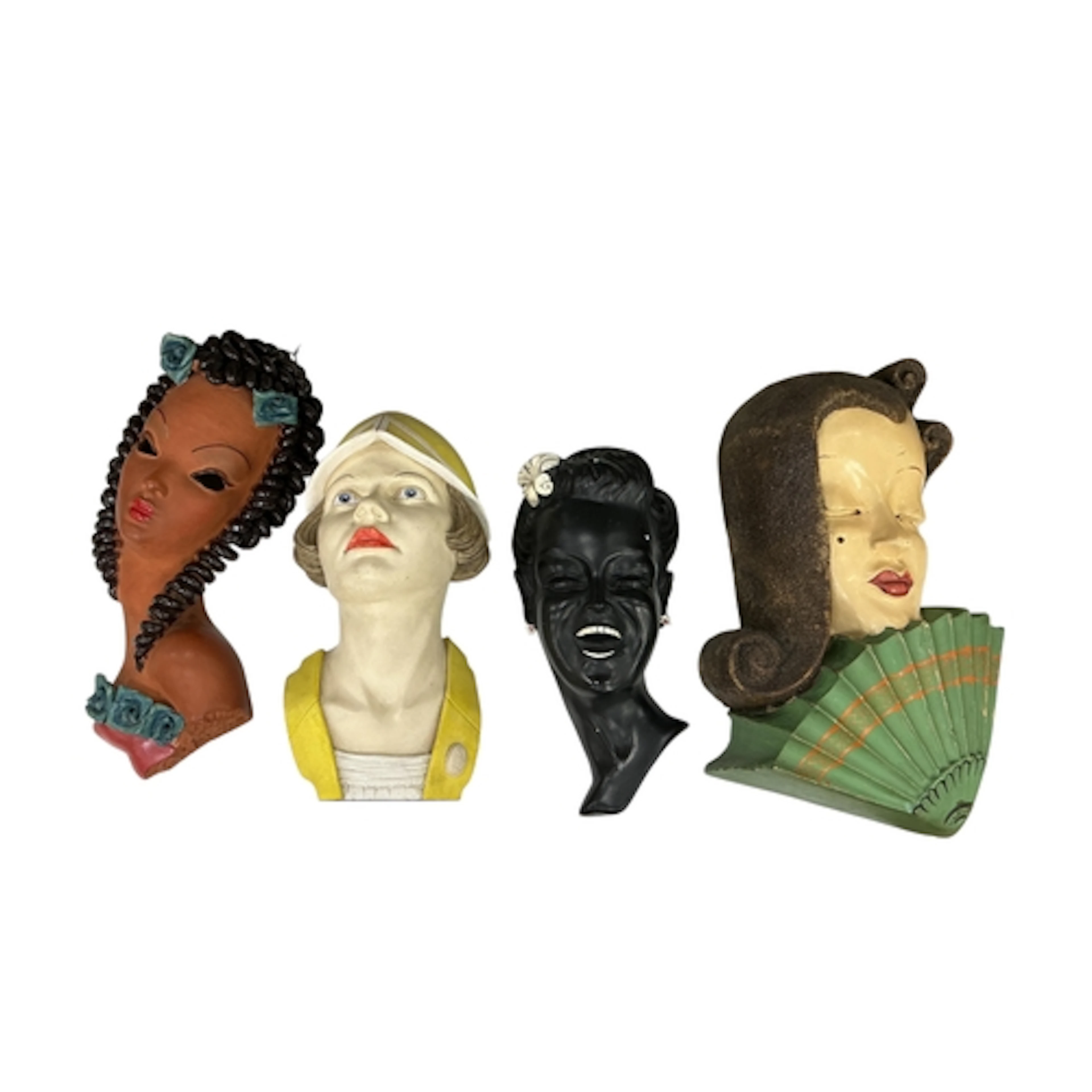 Four Art Deco style wall masks to include a terracotta examp...