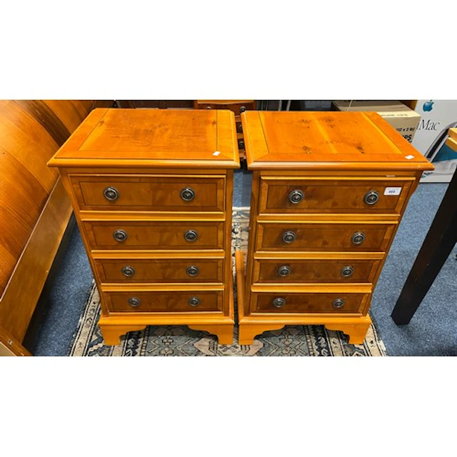 Pair of reproduction yew wood bedside chests of four drawers...