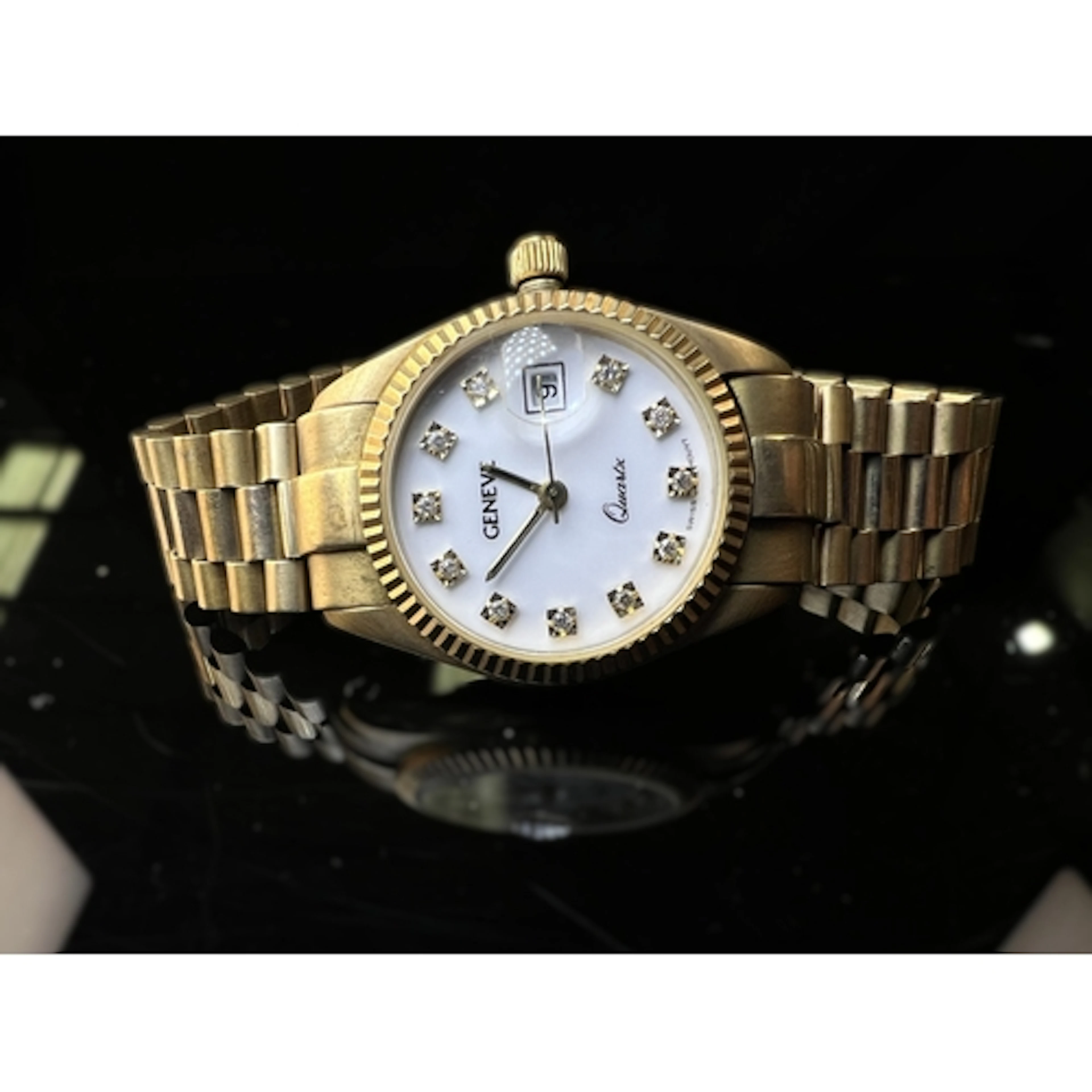 A ladies Geneve quartz 9 carat watch with case and strap mar...