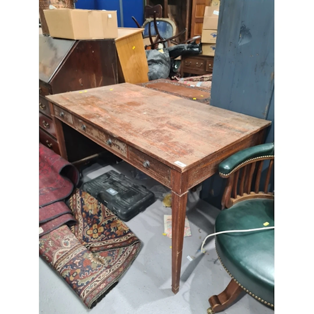 A rustic Desk fitted three drawers raised on square tapering...