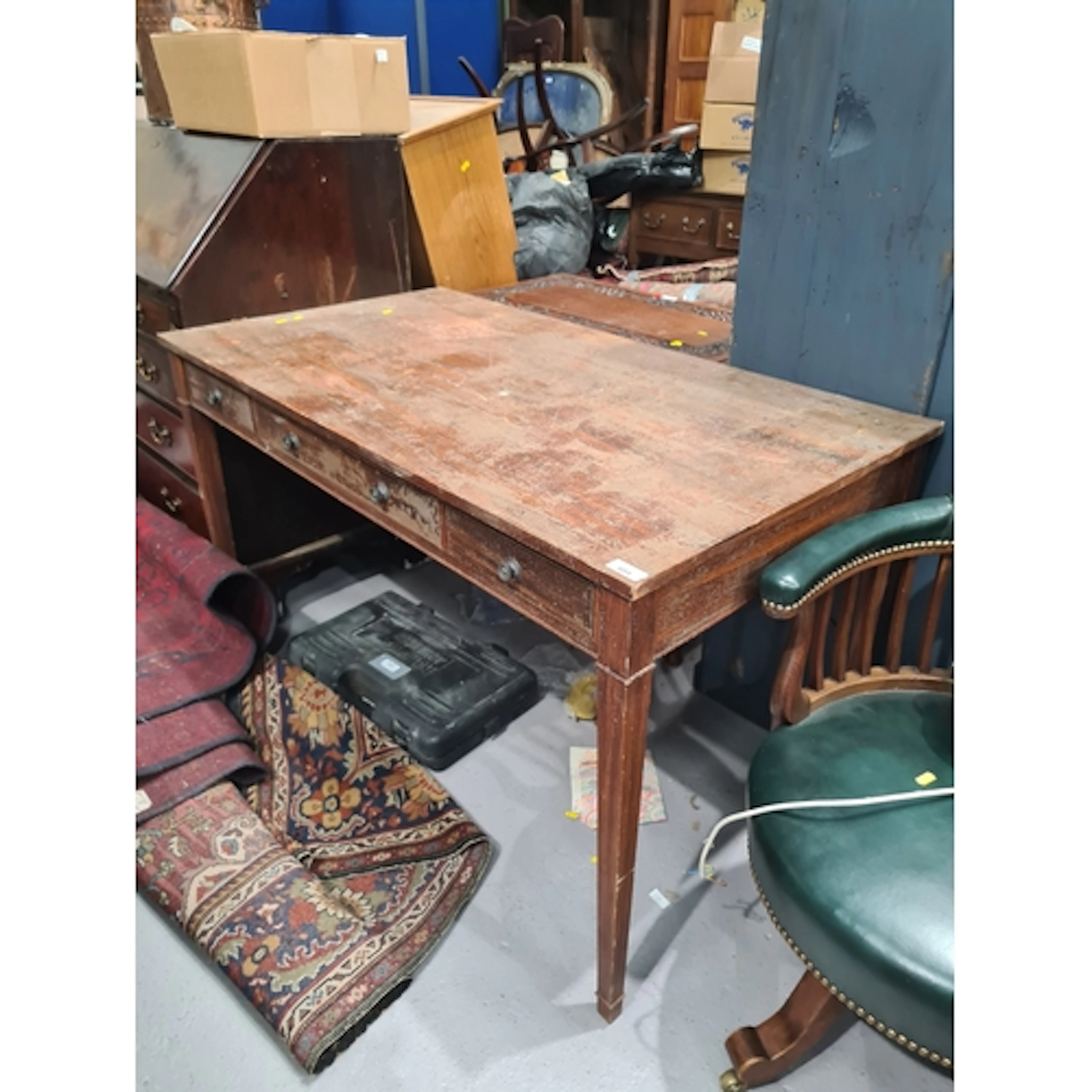 A rustic Desk fitted three drawers raised on square tapering...