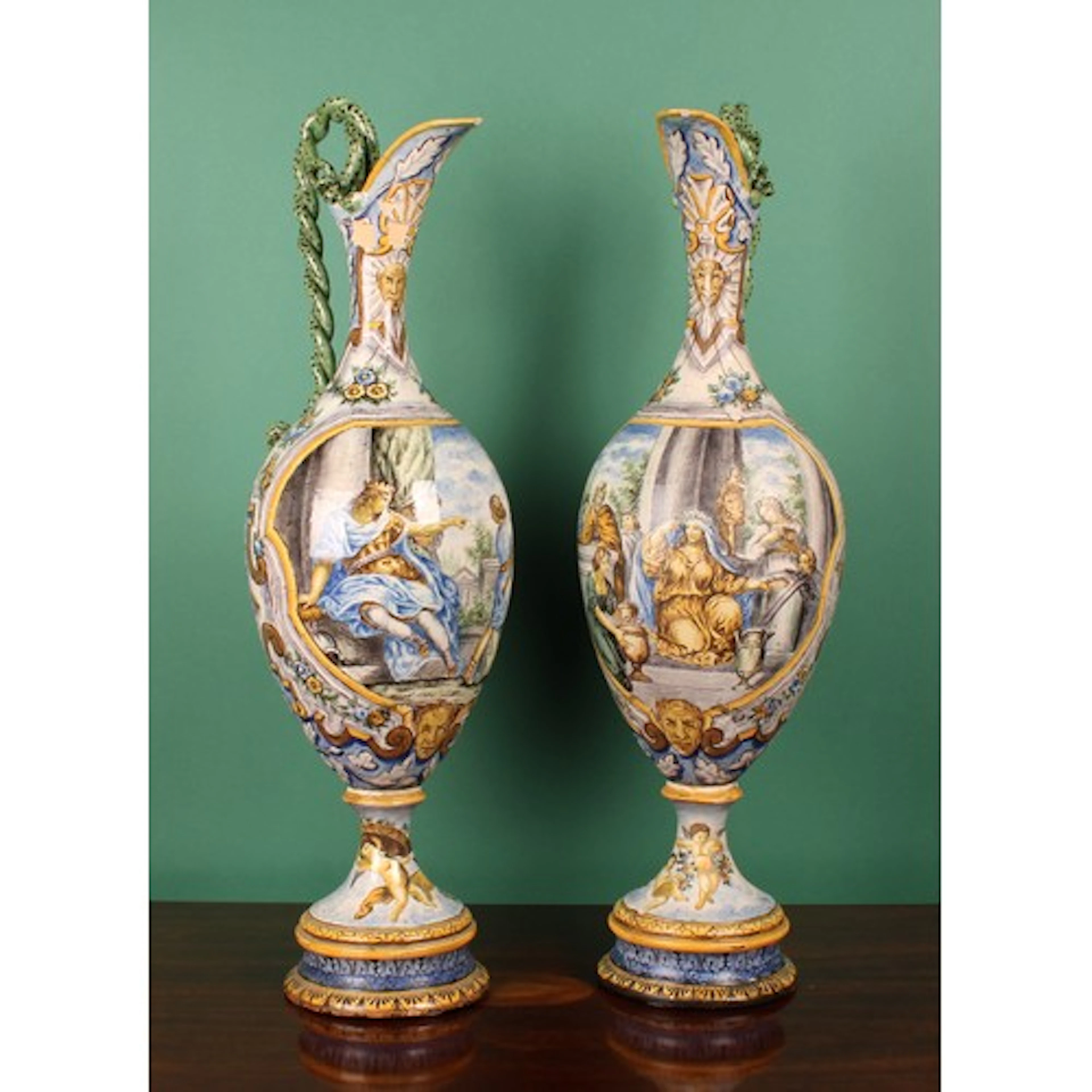 A pair of large Italian maiolica ovoid pedestal ewers, paint...