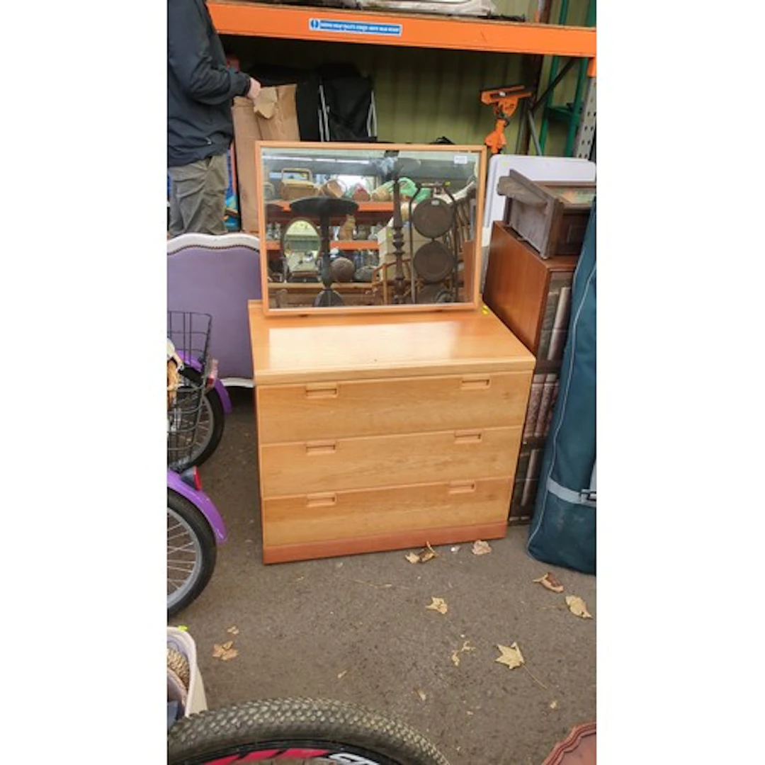 Chest of three long drawers in a light wood-effect finish, w...