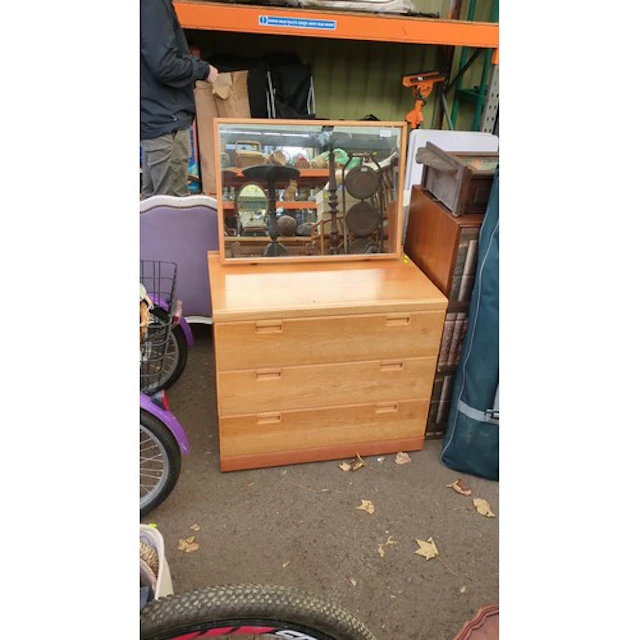 Chest of three long drawers in a light wood-effect finish, w...