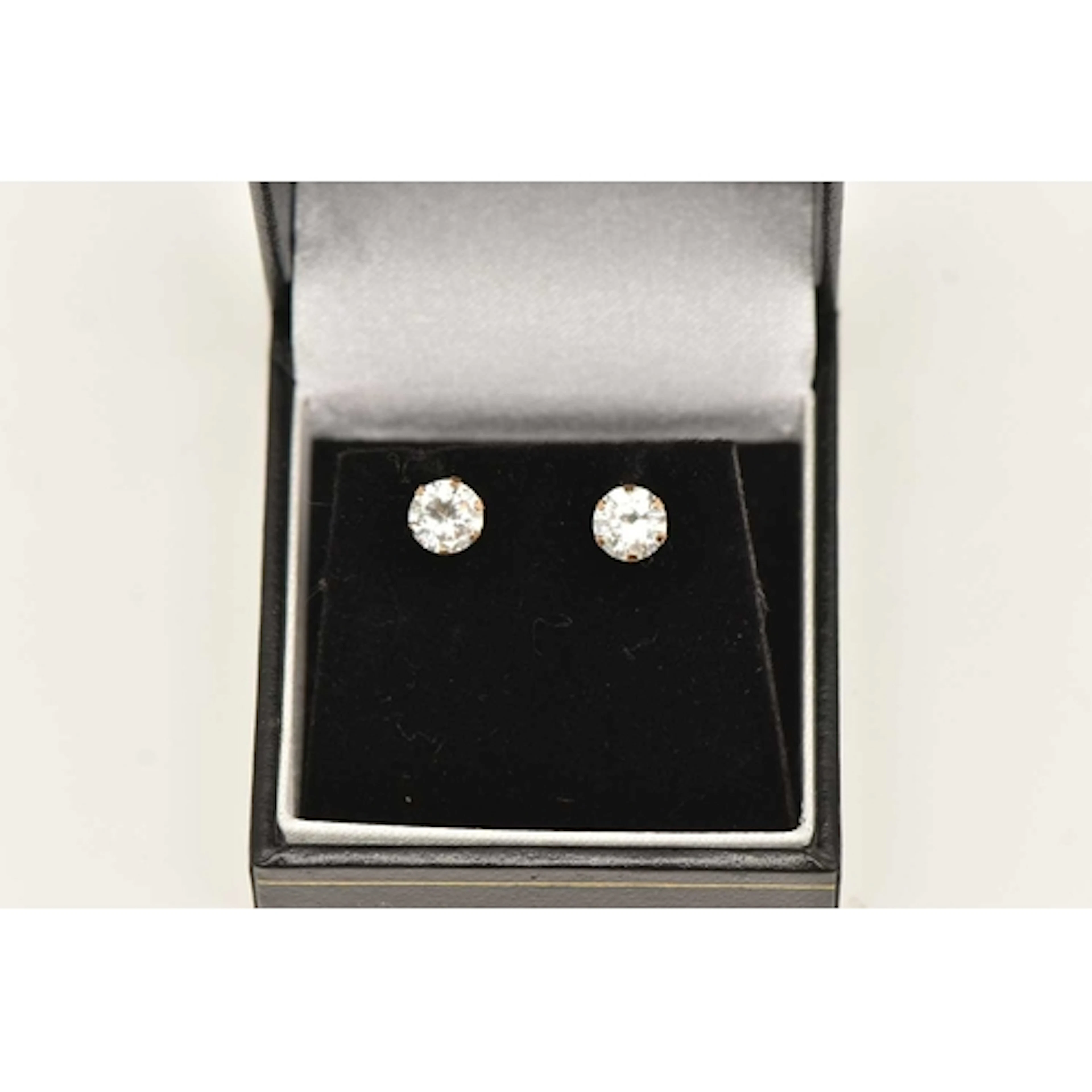 A PAIR OF CUBIC ZIRCONIA STUD EARRINGS, yellow metal posts a...
