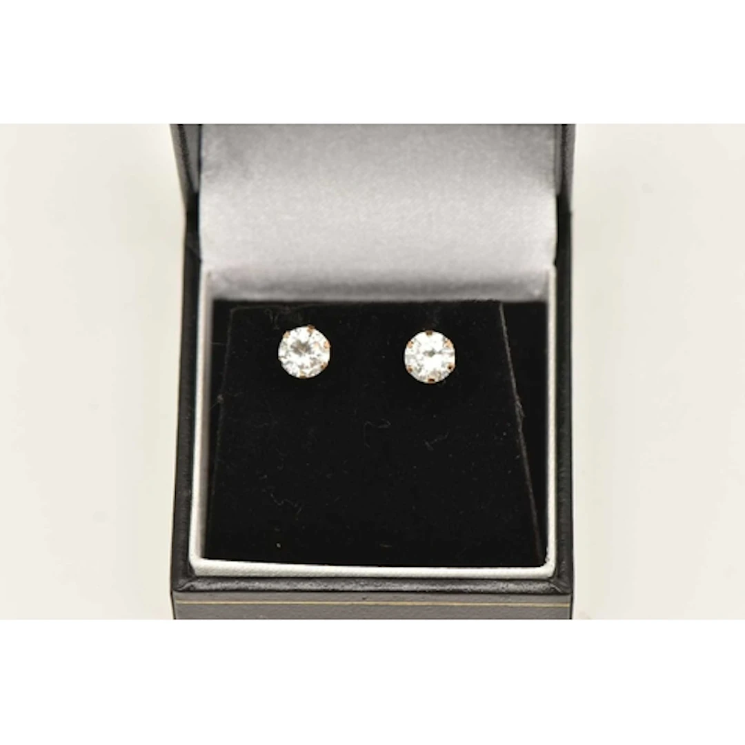 A PAIR OF CUBIC ZIRCONIA STUD EARRINGS, yellow metal posts a...