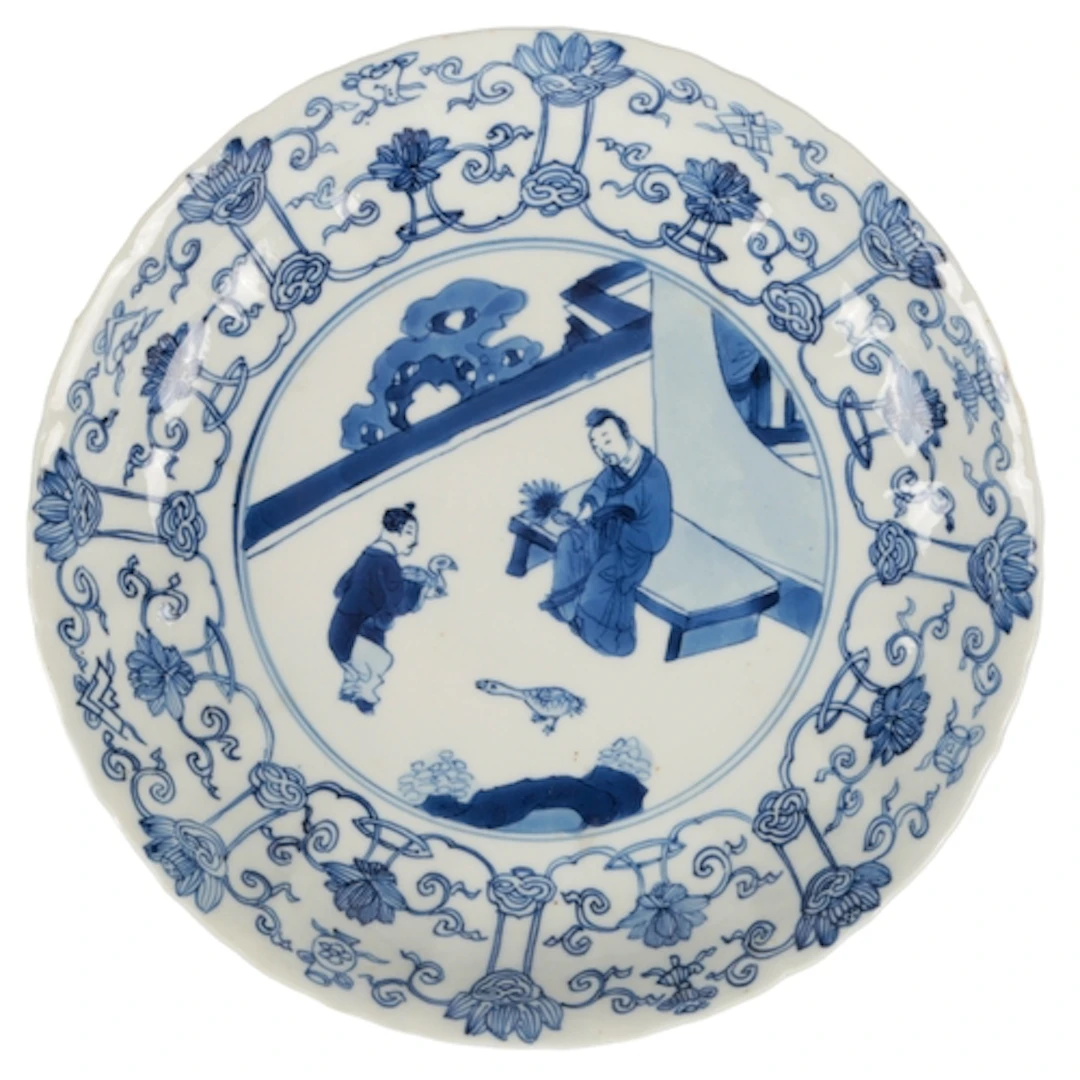 A Chinese blue and white 'scholar and boy' dish, Kangxi mark...