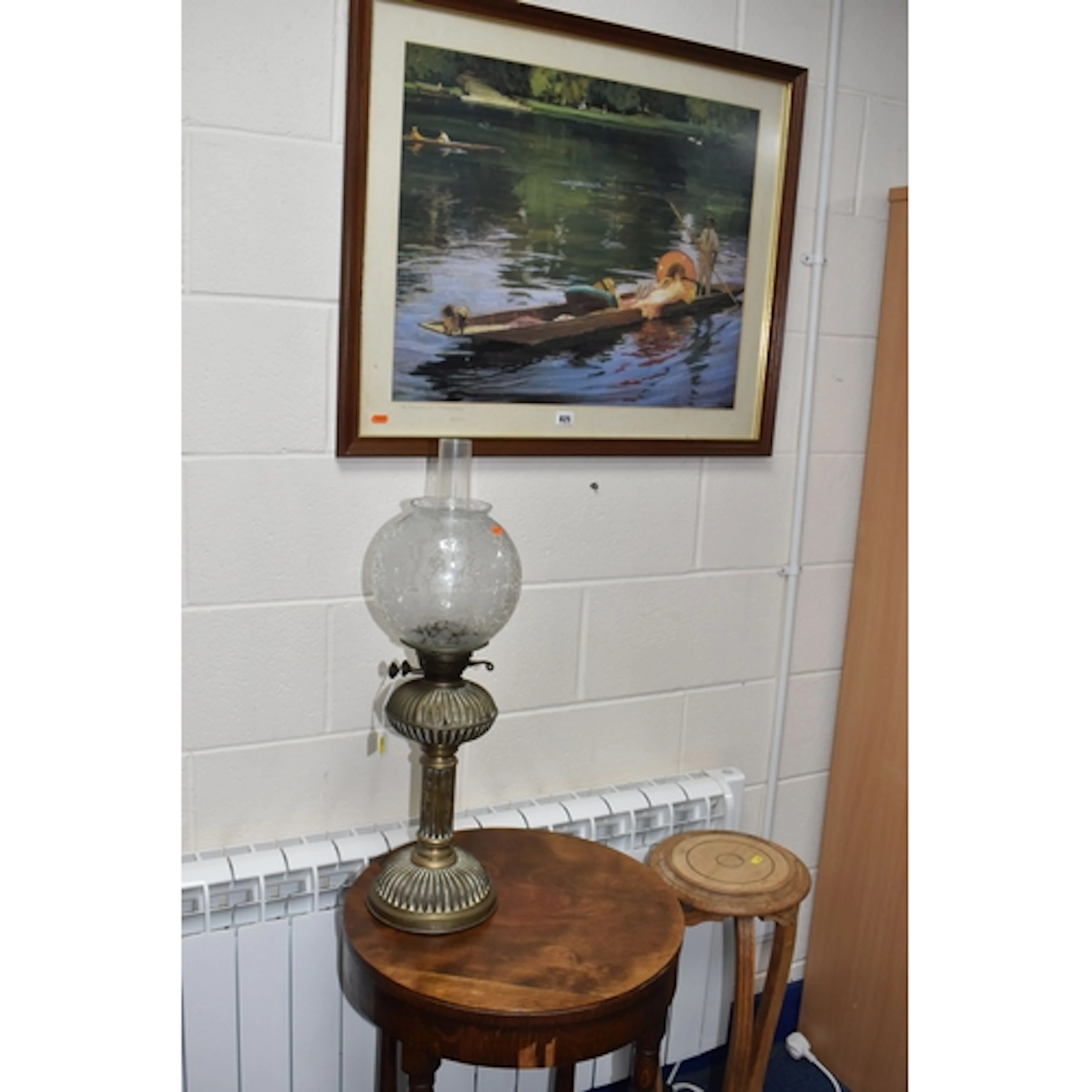 AN OIL LAMP, A TABLE, A PLANT STAND AND A PRINT, the brass b...