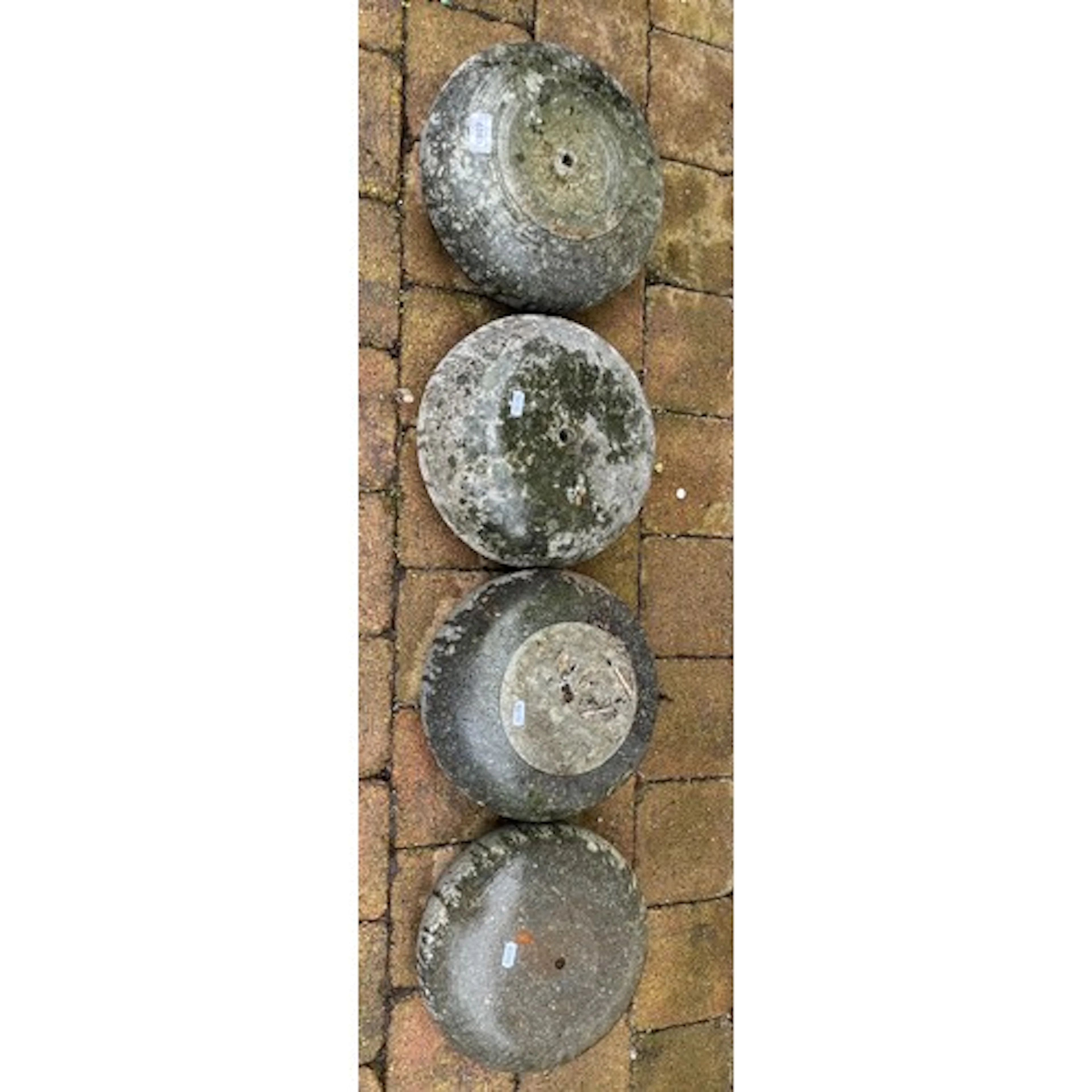 Four assorted curling stones(one damaged)