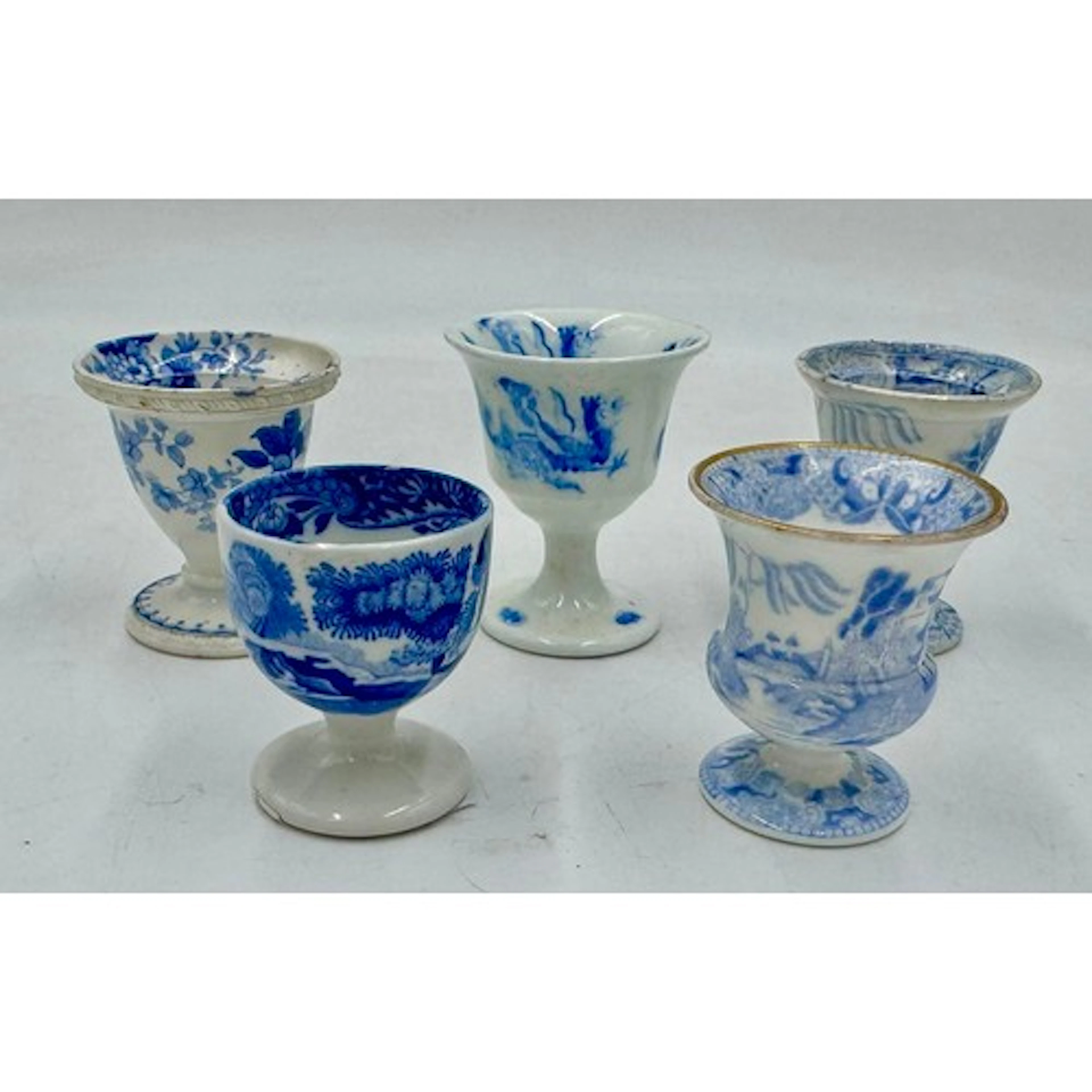 Five early 19th century blue and white transfer-printed foot...