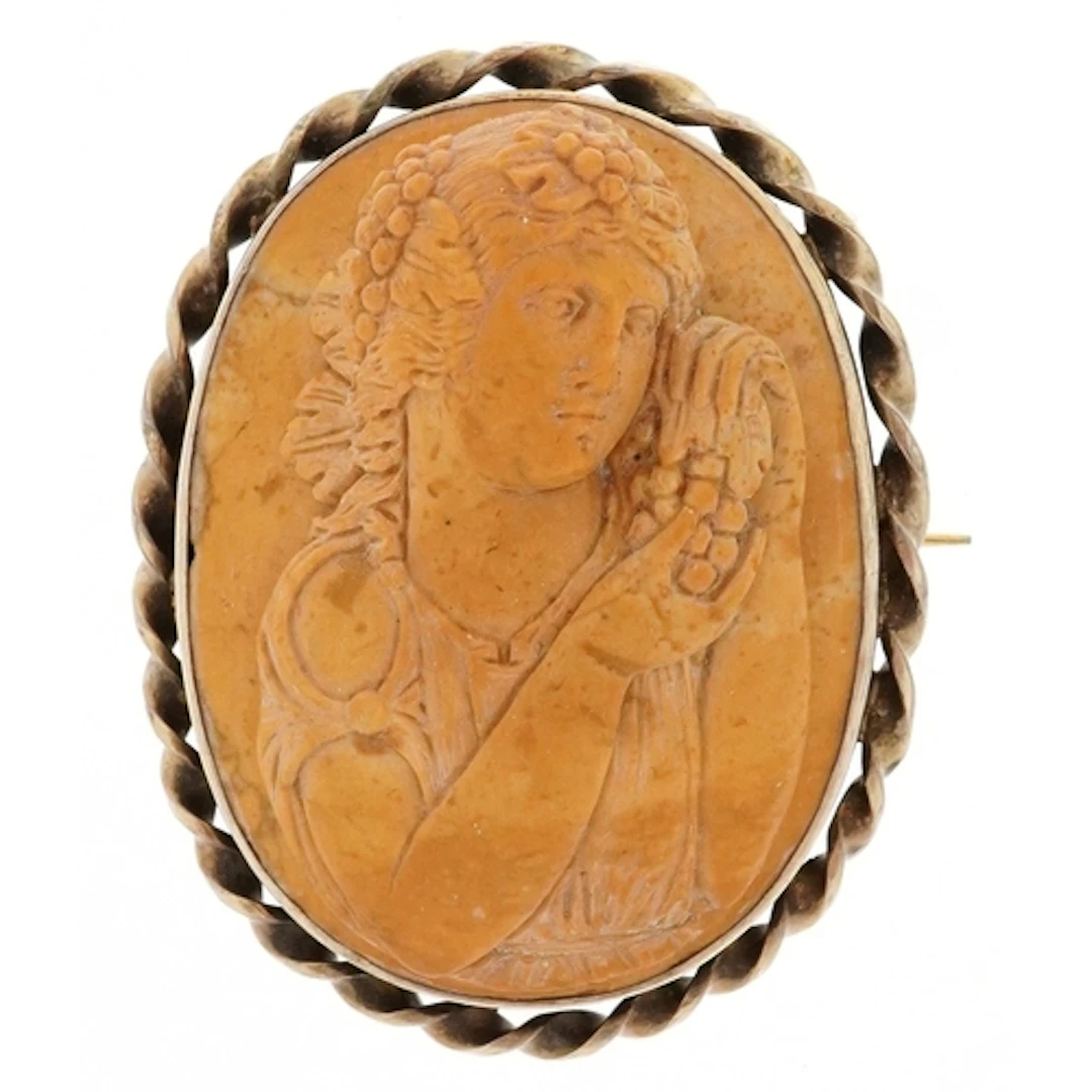 Victorian lava cameo brooch carved with a female holding fru...