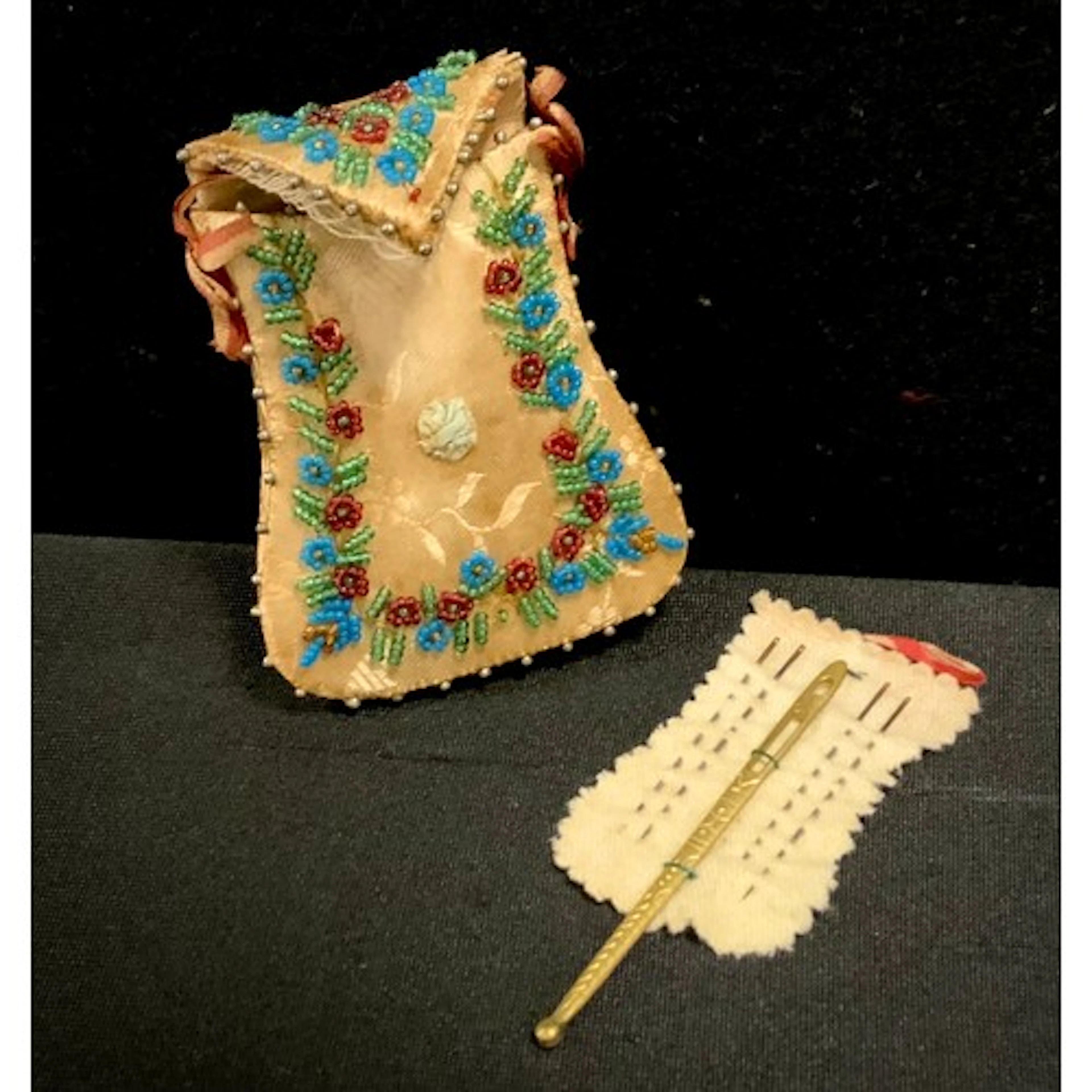 A George III silk and beadwork sewing needle case, enveloped...