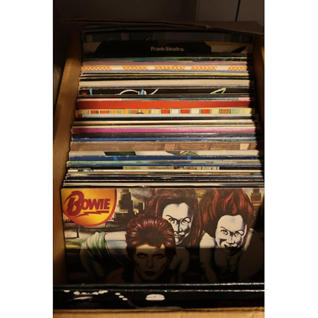 Box containing mixed vinyl records to include David Bowie, T...