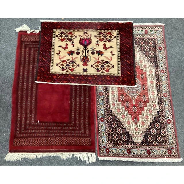 A Persian style rug, red brown and cream coloured 71x136cm;...