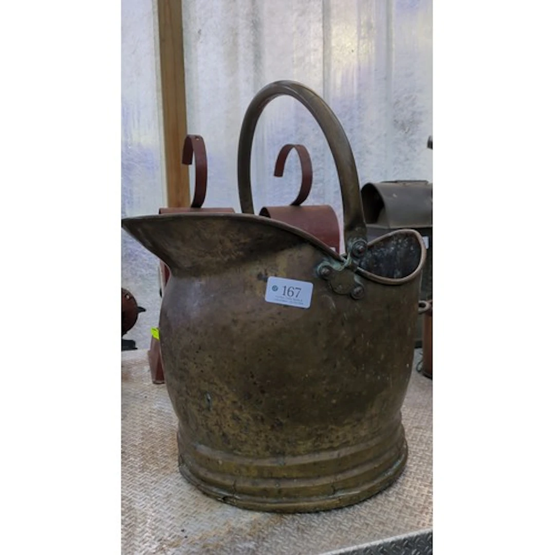 Brass helmet-form coal scuttle with a flared pouring lip