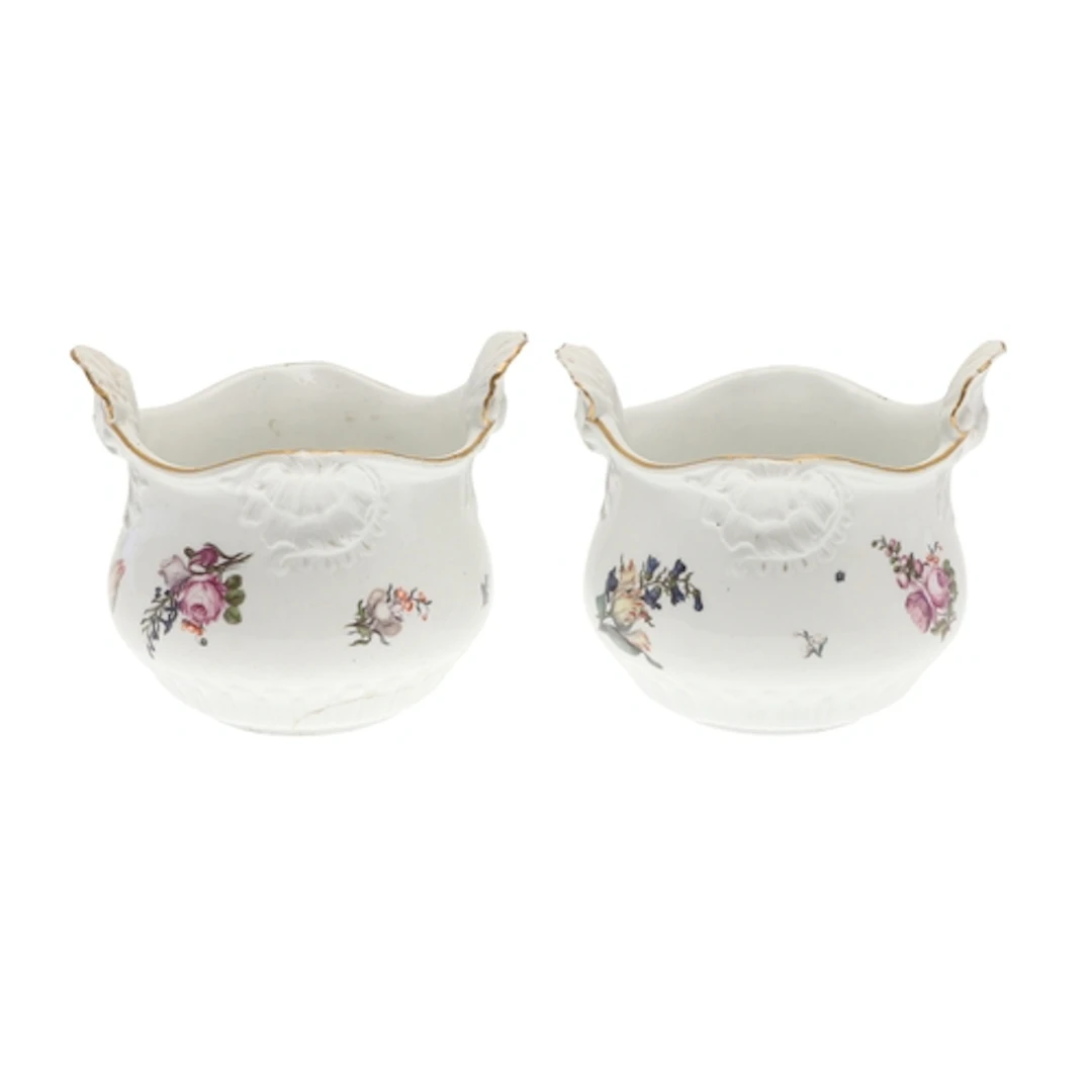 PAIR OF MEISSEN CACHE POTS. The cache pots painted with spra...