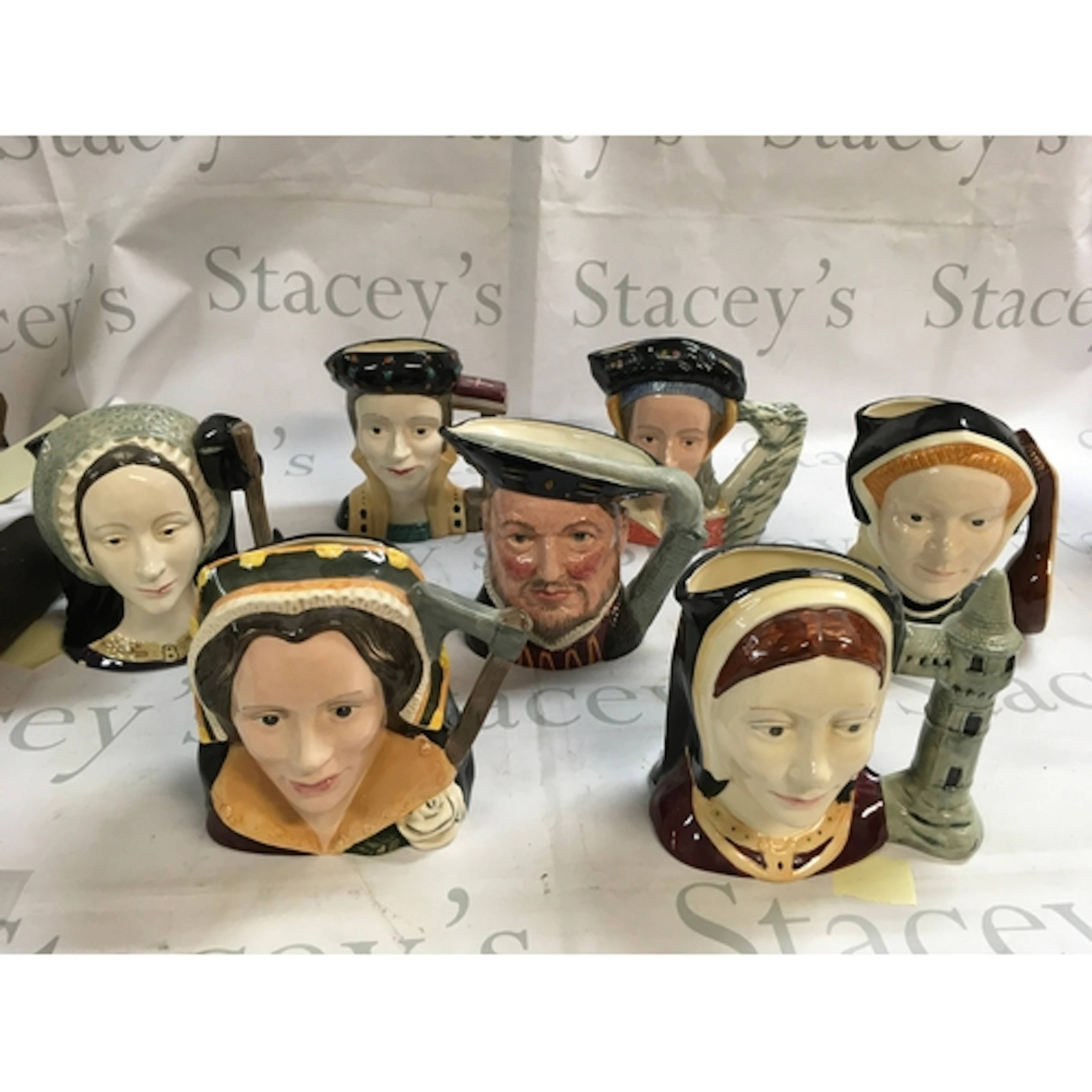 A collection of Doulton Character jugs including Henry VII a...