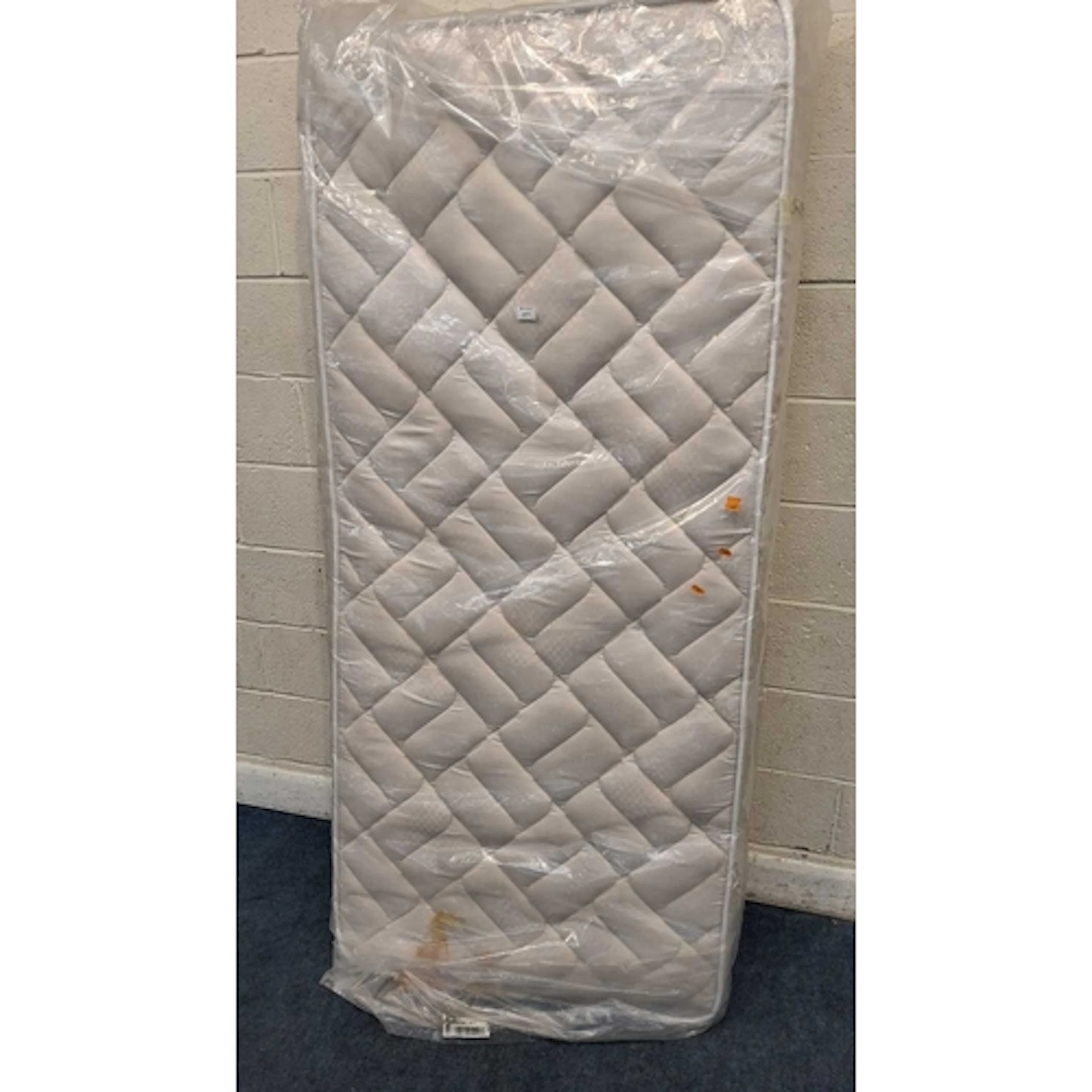 A NIKALIN 3FT SINGLE MATTRESS in a ripped cover, unknown if...