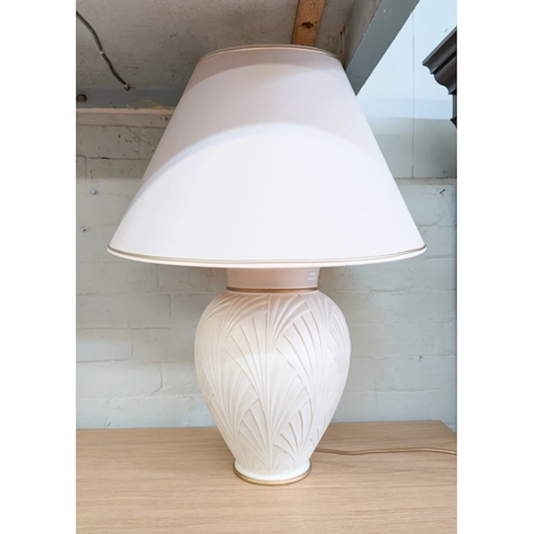 A large cream bulbous vase shaped table lamp with shade