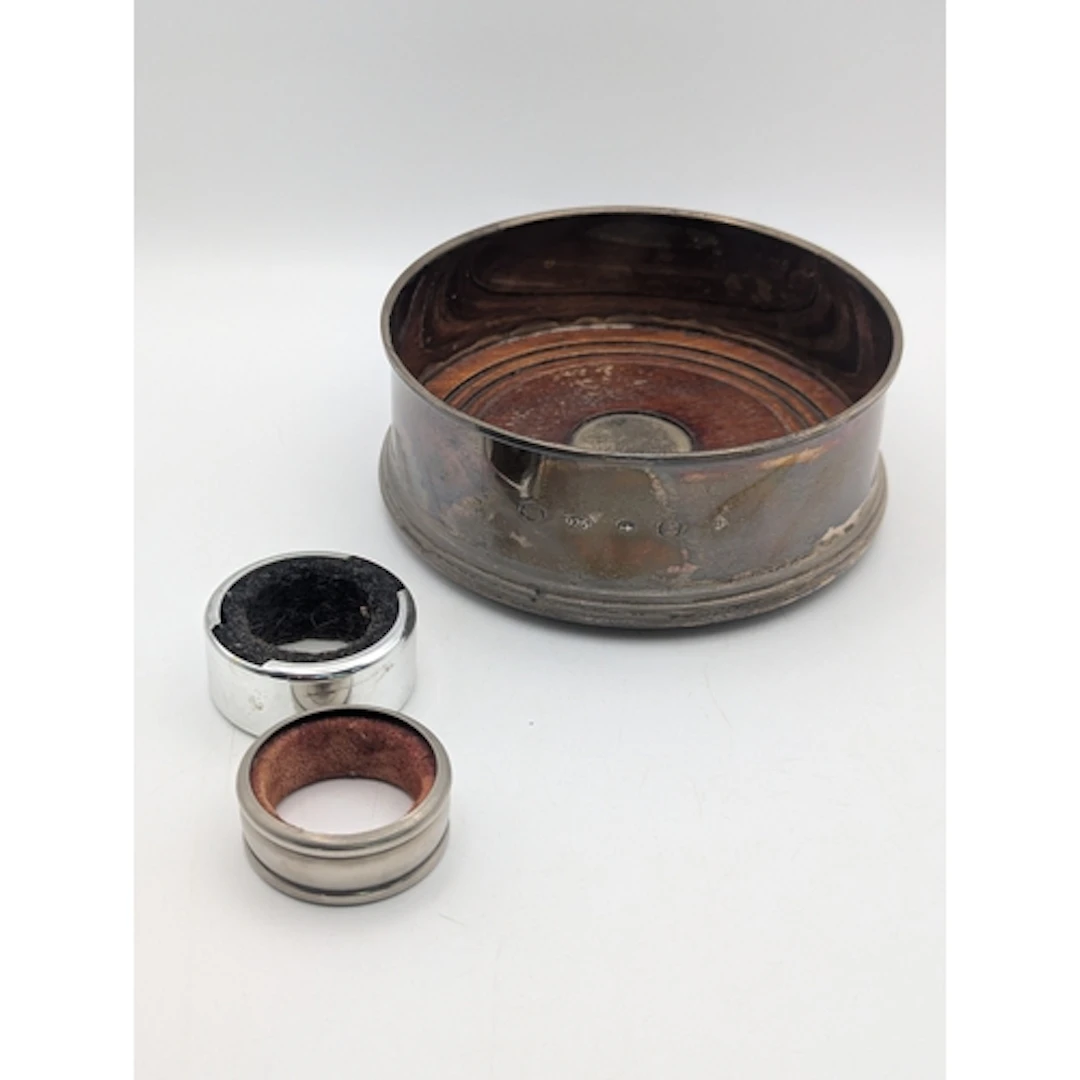 A silver bottle coaster, hallmarked Birmingham 2000, togethe...