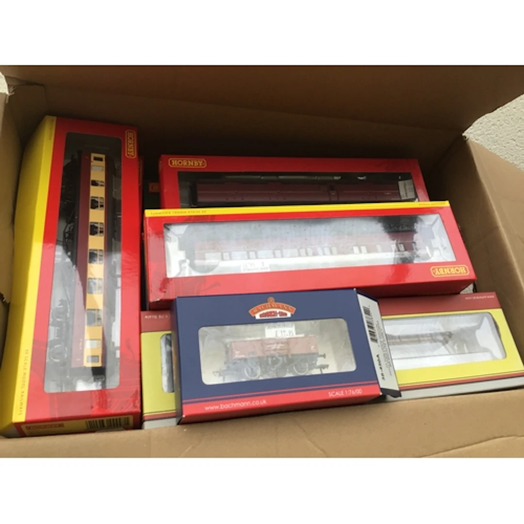 A collection of boxed 00 gauge model railway wagons and coac...
