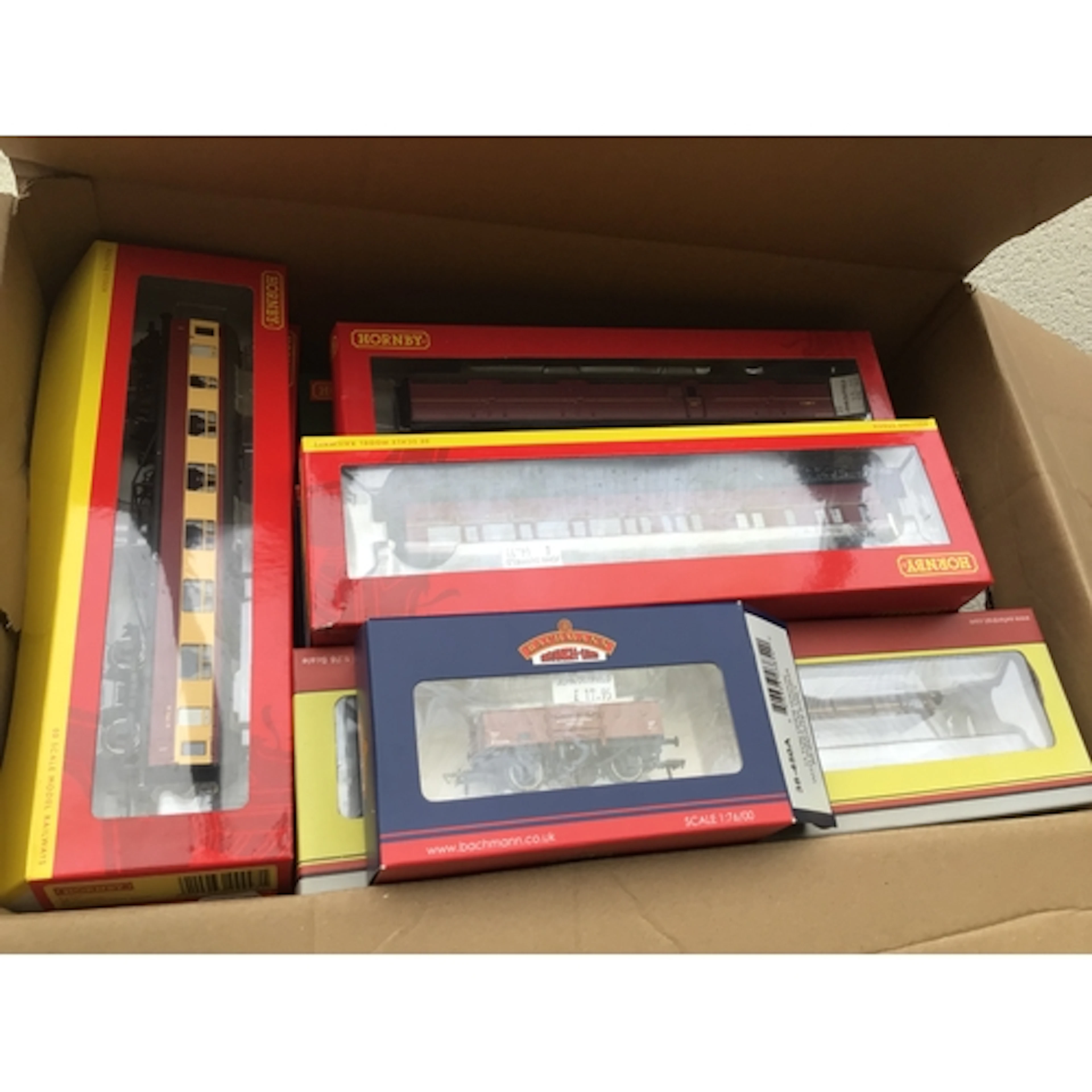 A collection of boxed 00 gauge model railway wagons and coac...
