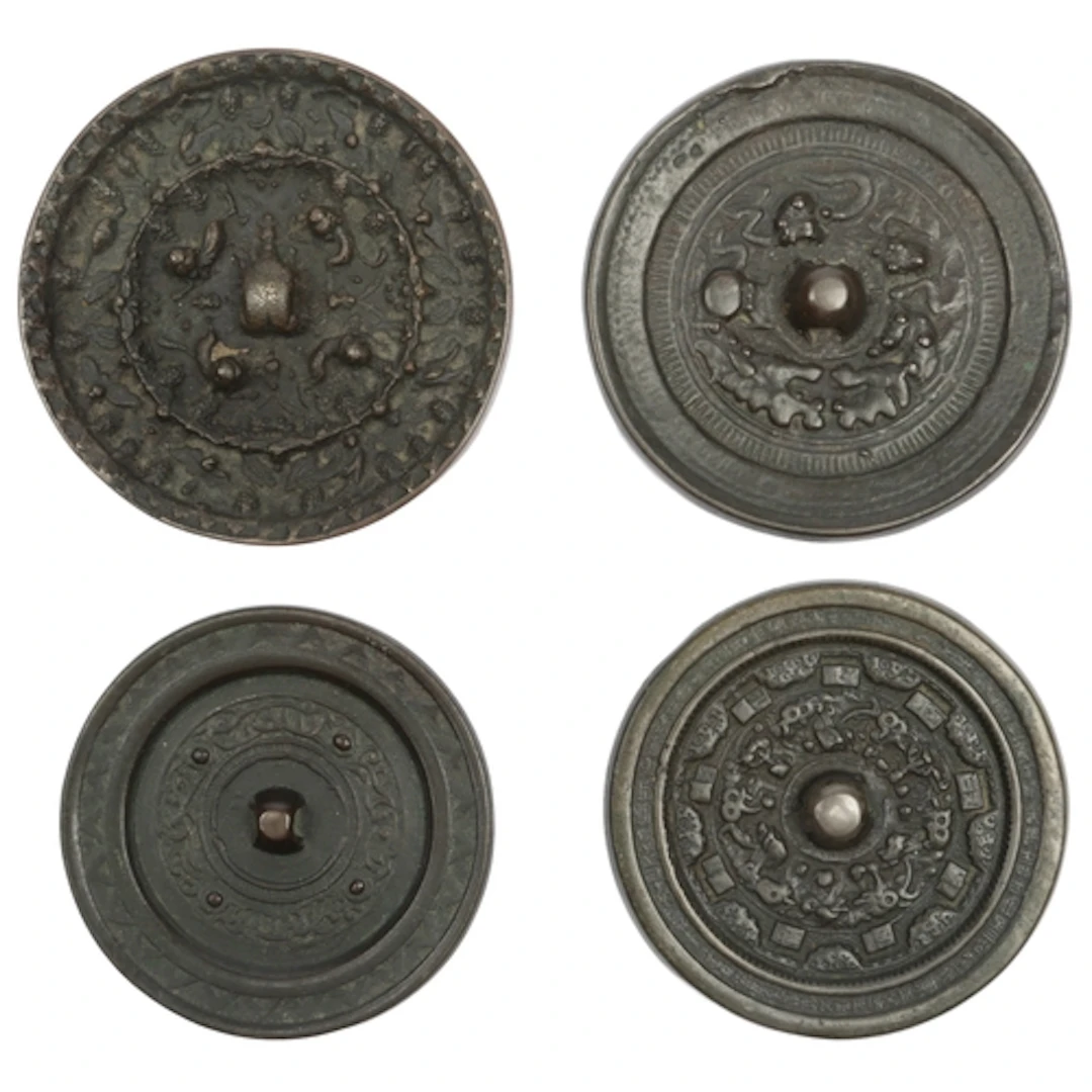 Four Chinese bronze mirrors, Song dynasty or later, each rev...