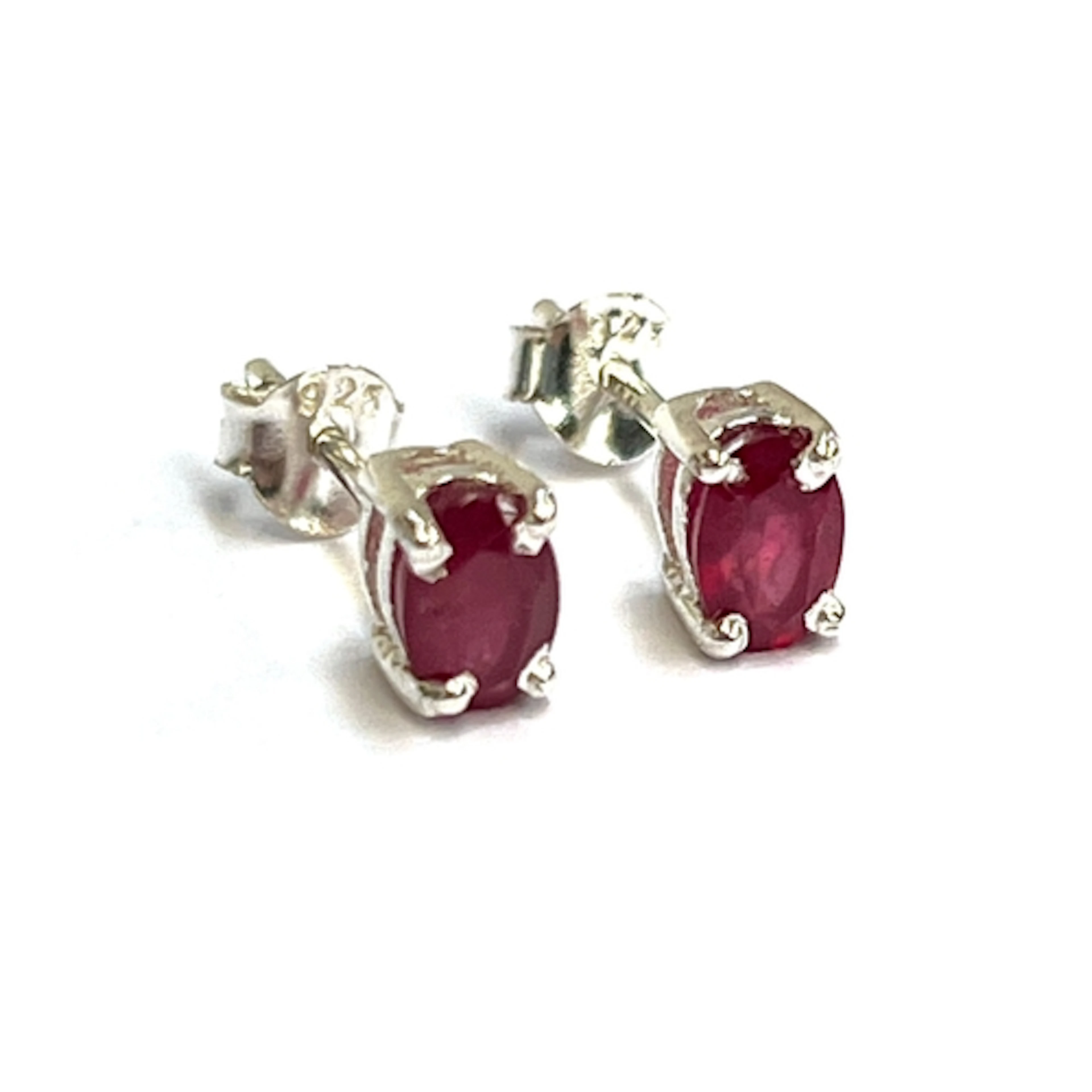 Pair of oval ruby studs, set in silver. Rubies approx. 0.90c...