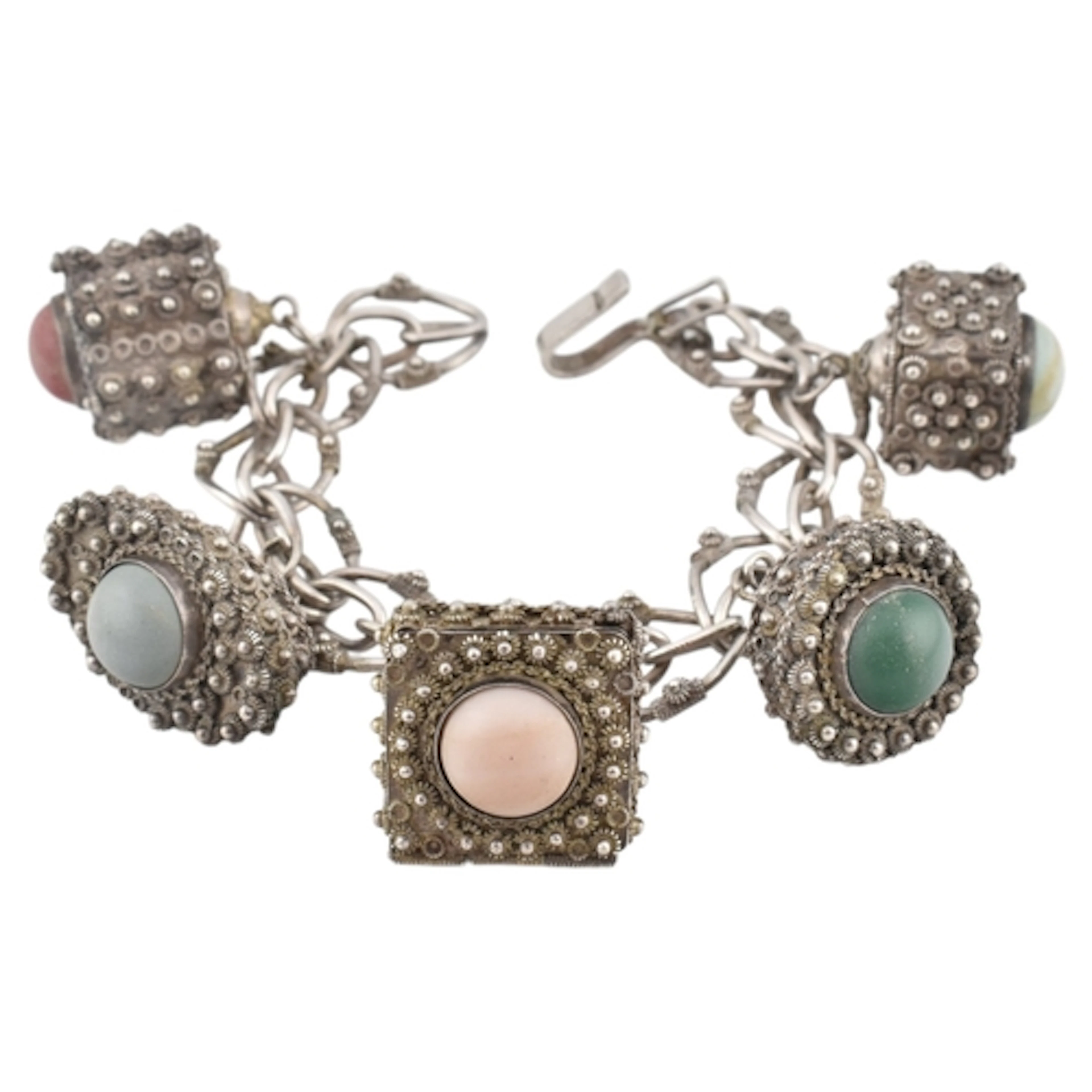 A white metal Etruscan revival charm bracelet. Five large ho...