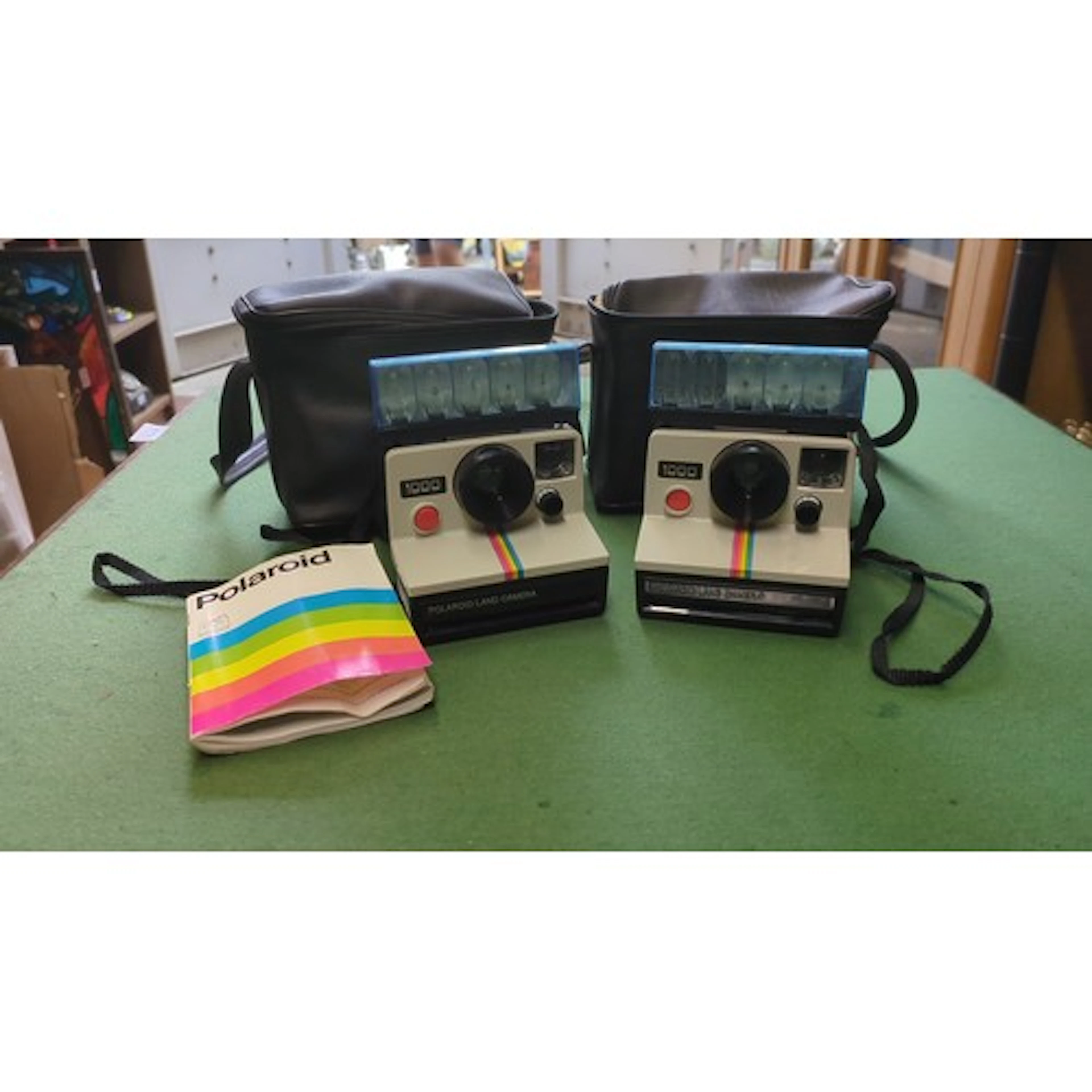 Polaroid Land Camera Model 1000 instant cameras, a pair, wit...