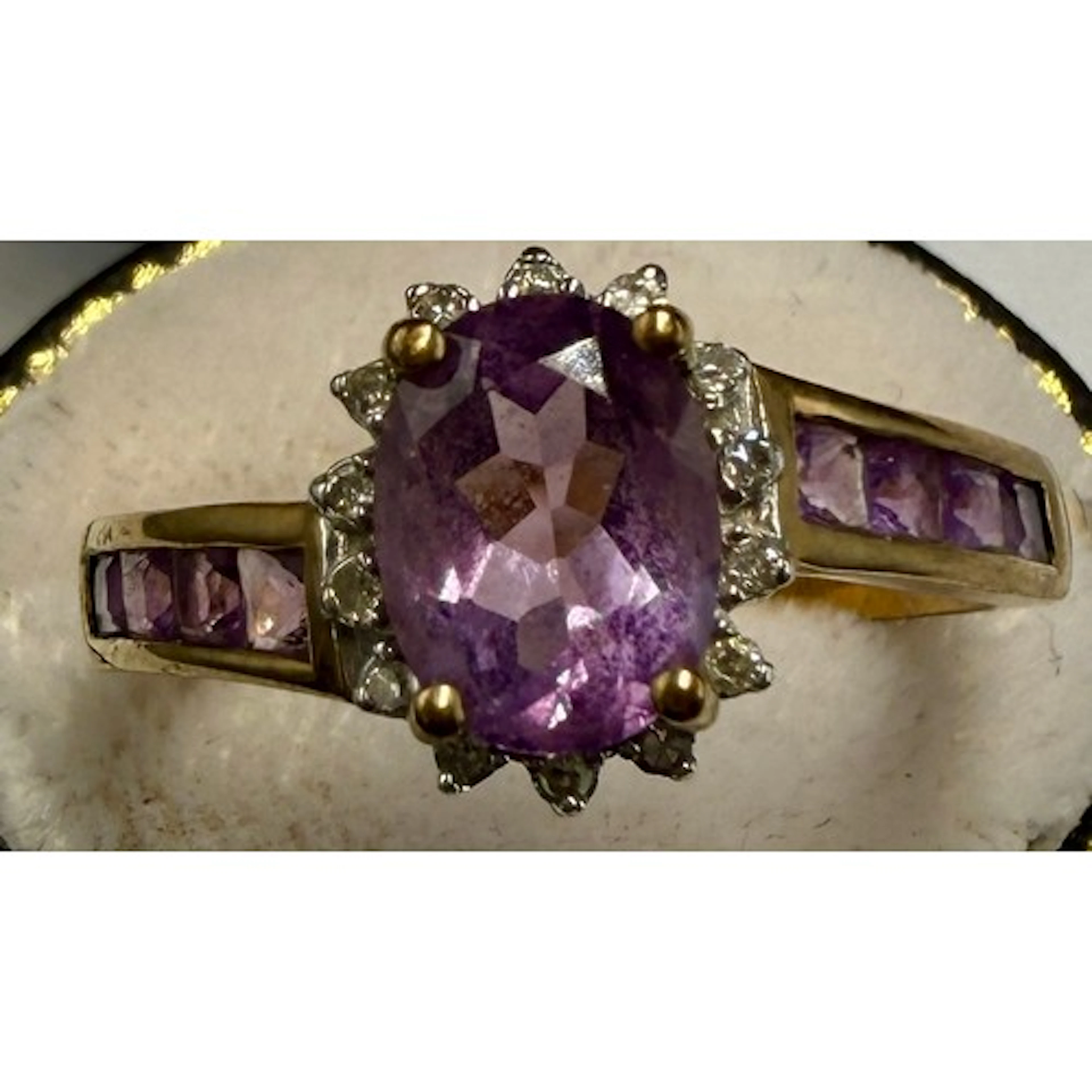 An amethyst and diamond ring set in 9 carat yellow gold with...