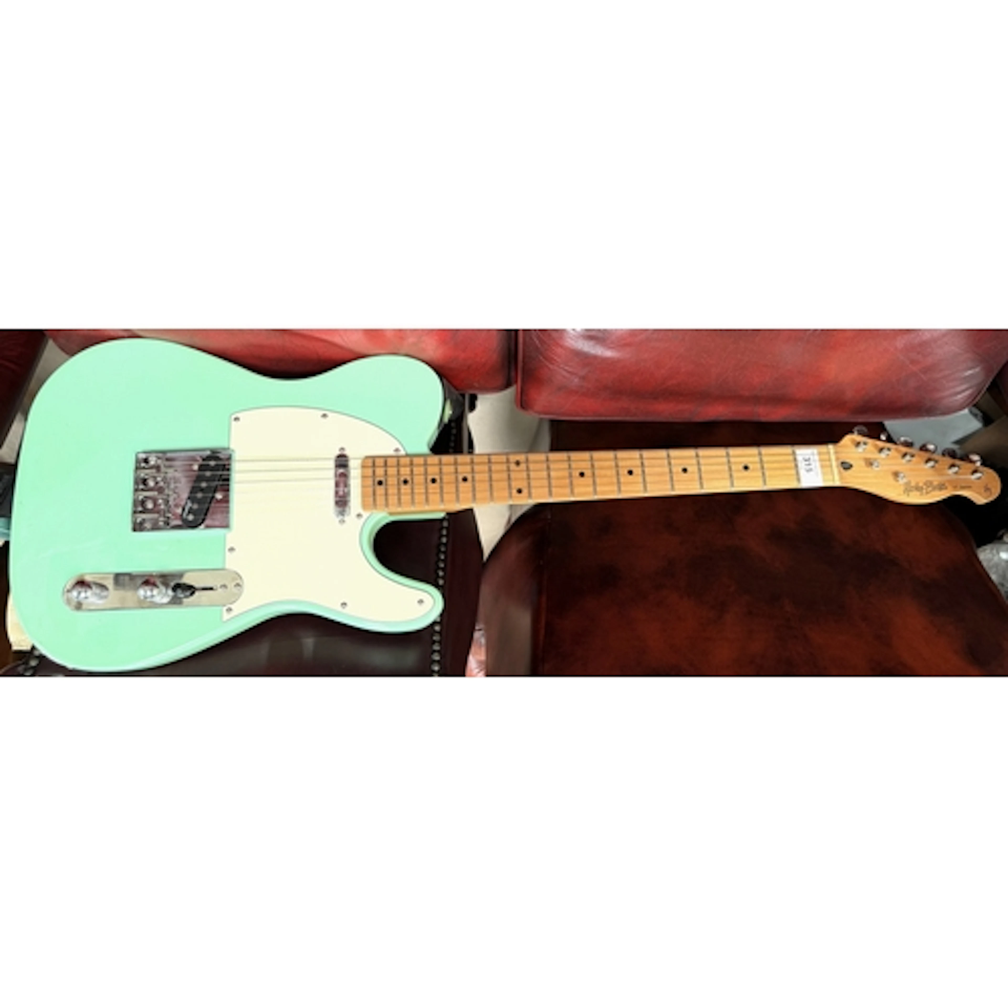 A Harley Benton VT series electric guitar with turquoise glo...