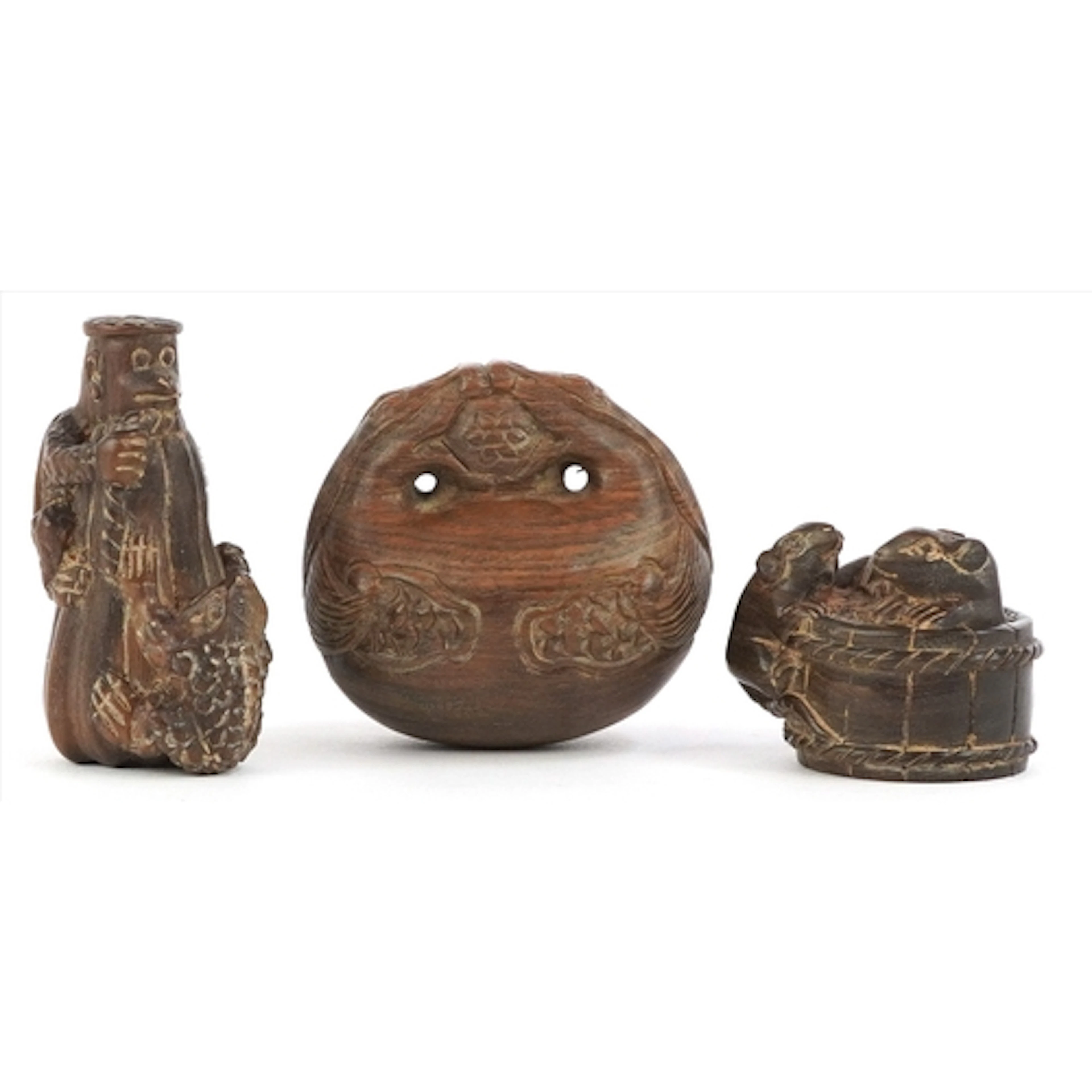 Three Japanese carved wood netsukes, one in the form of rats...