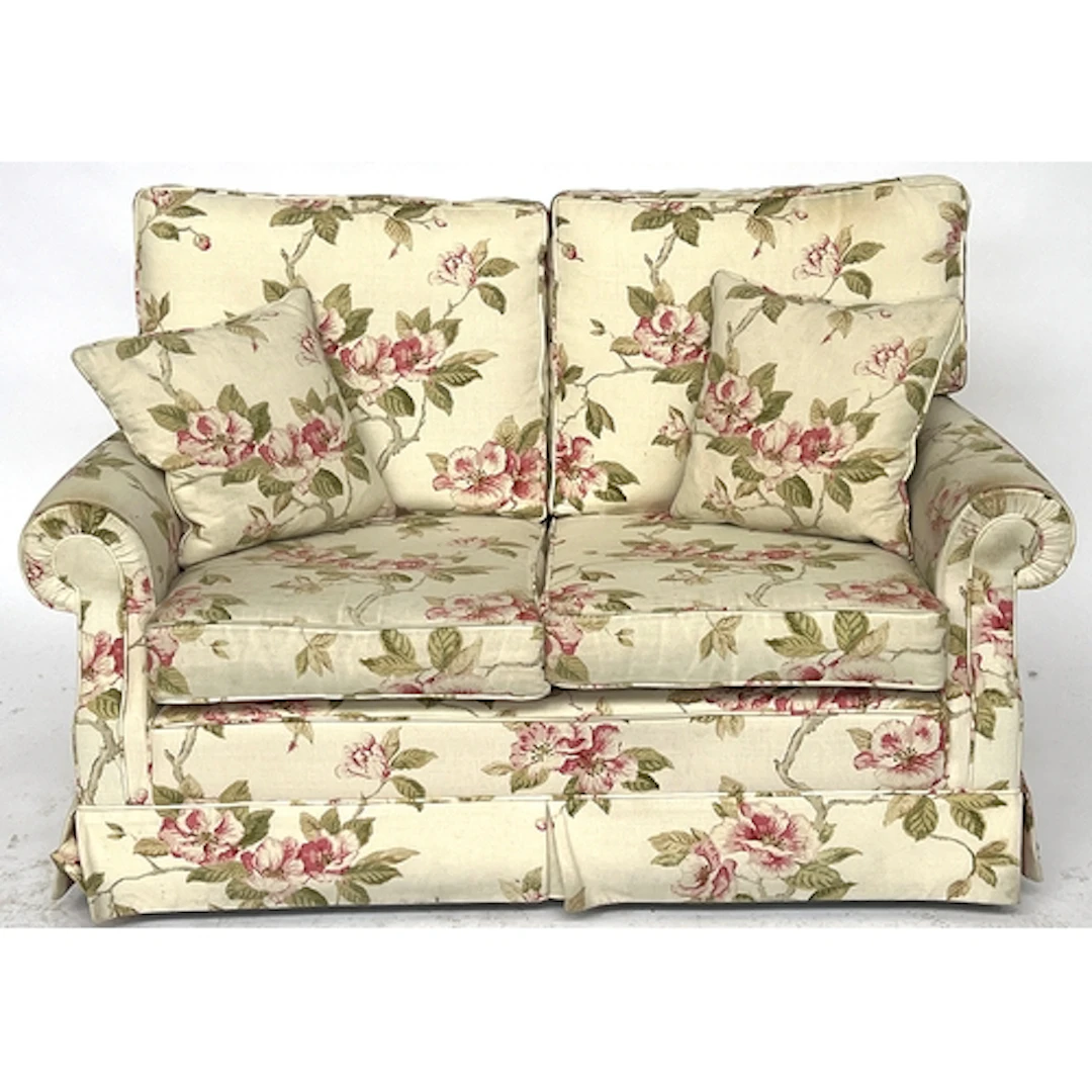 A modern two seater sofa in a pink floral print, 136cm wide
